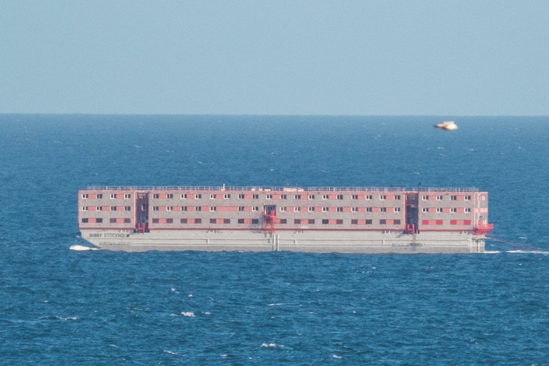 The Bibby Stockholm accommodation barge being towed to Falmouth