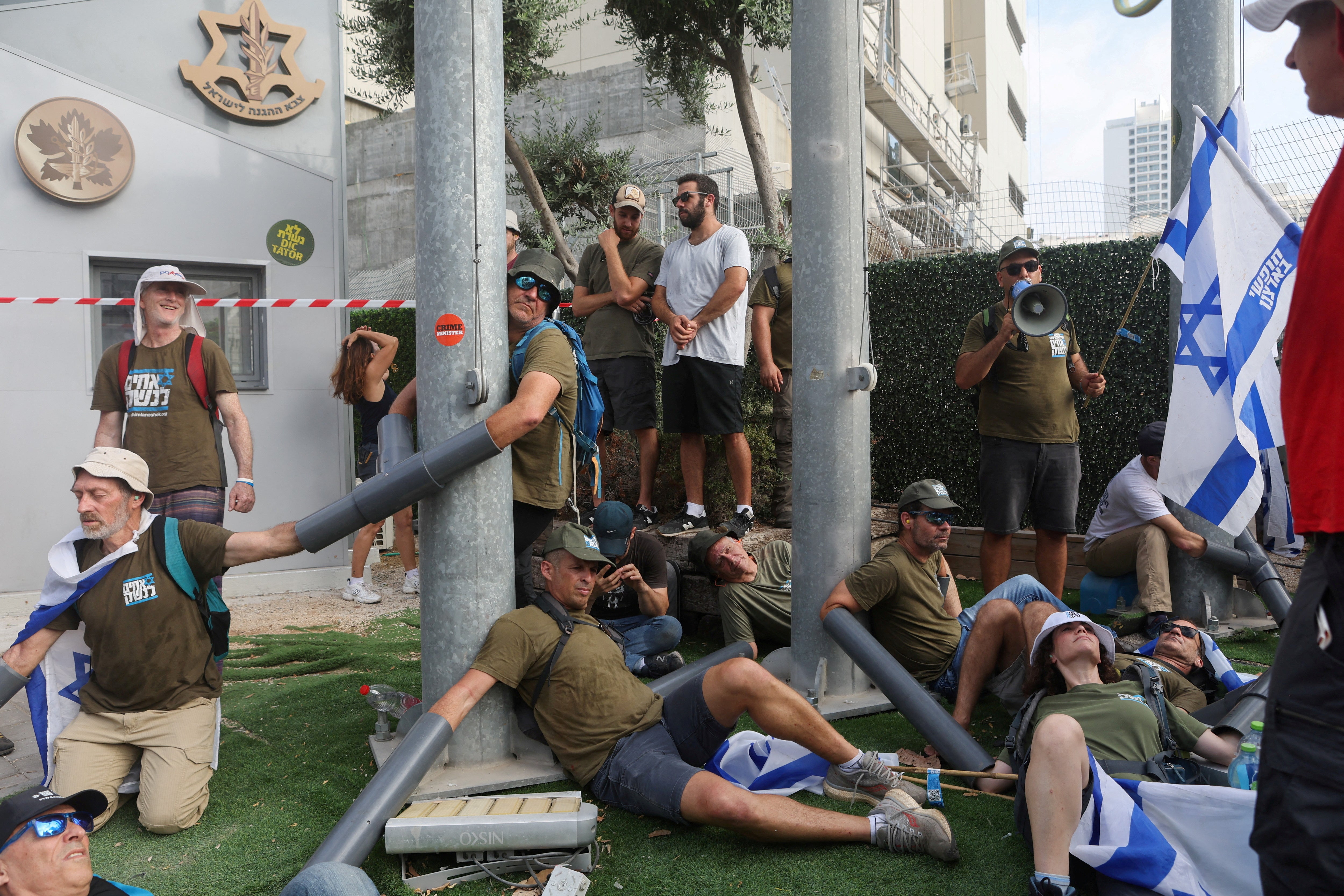 People chain themselves together in front of the Ministry of Defense on the ‘Day of National Resistance’ in protest against Israeli Prime Minister Benjamin Netanyahu and his nationalist coalition government’s judicial overhaul, in Tel Aviv, Israel.