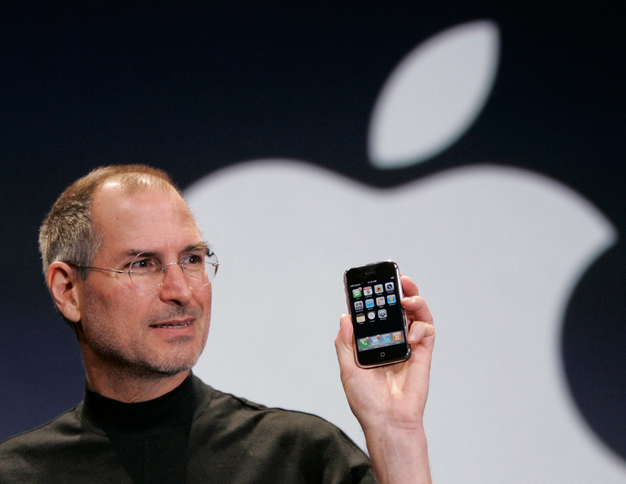 The late Steve Jobs holds up an iPhone at the MacWorld Conference in January 2007