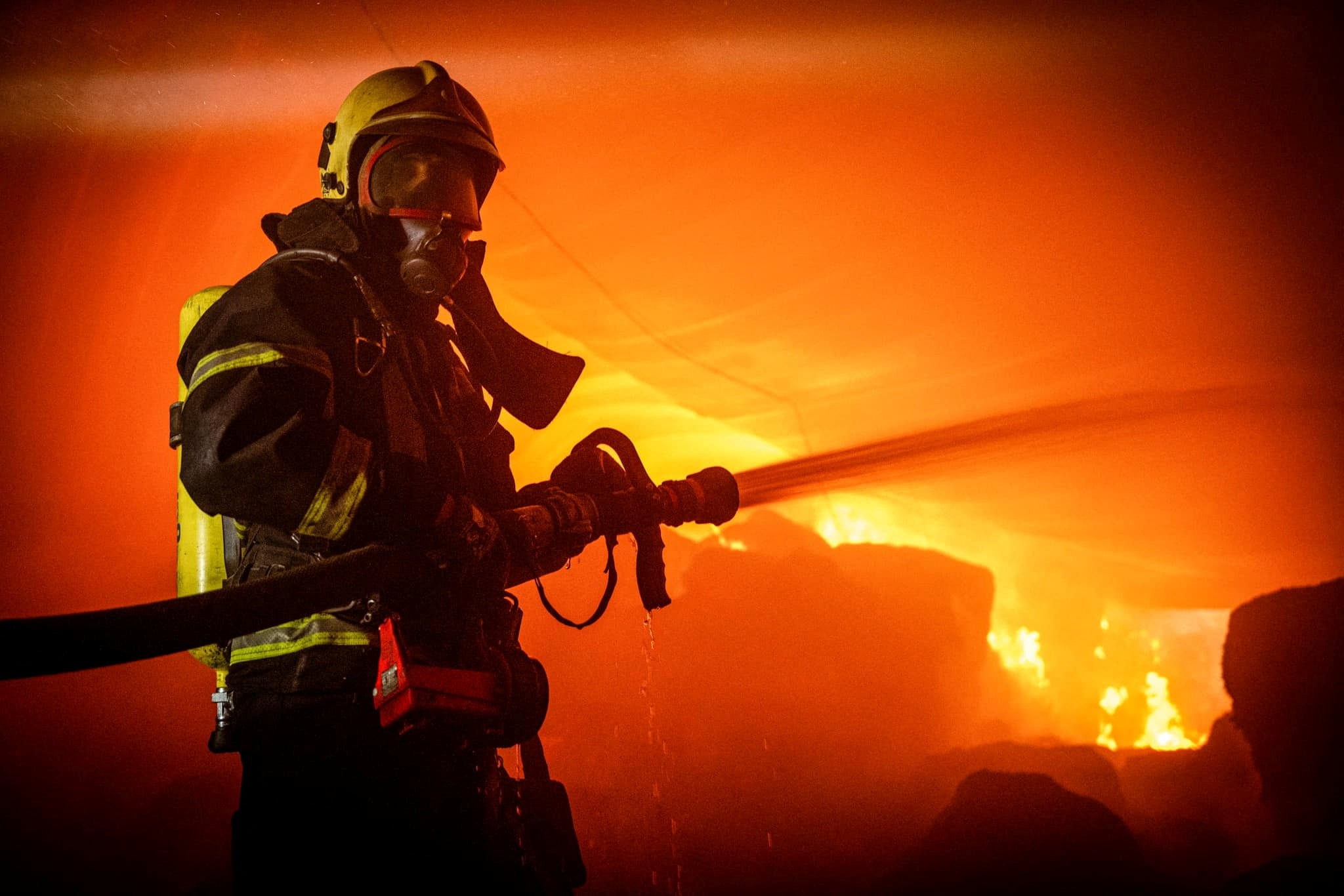 A firefighter works at a site of storage facilities hit during Russian missile strikes on Odesa