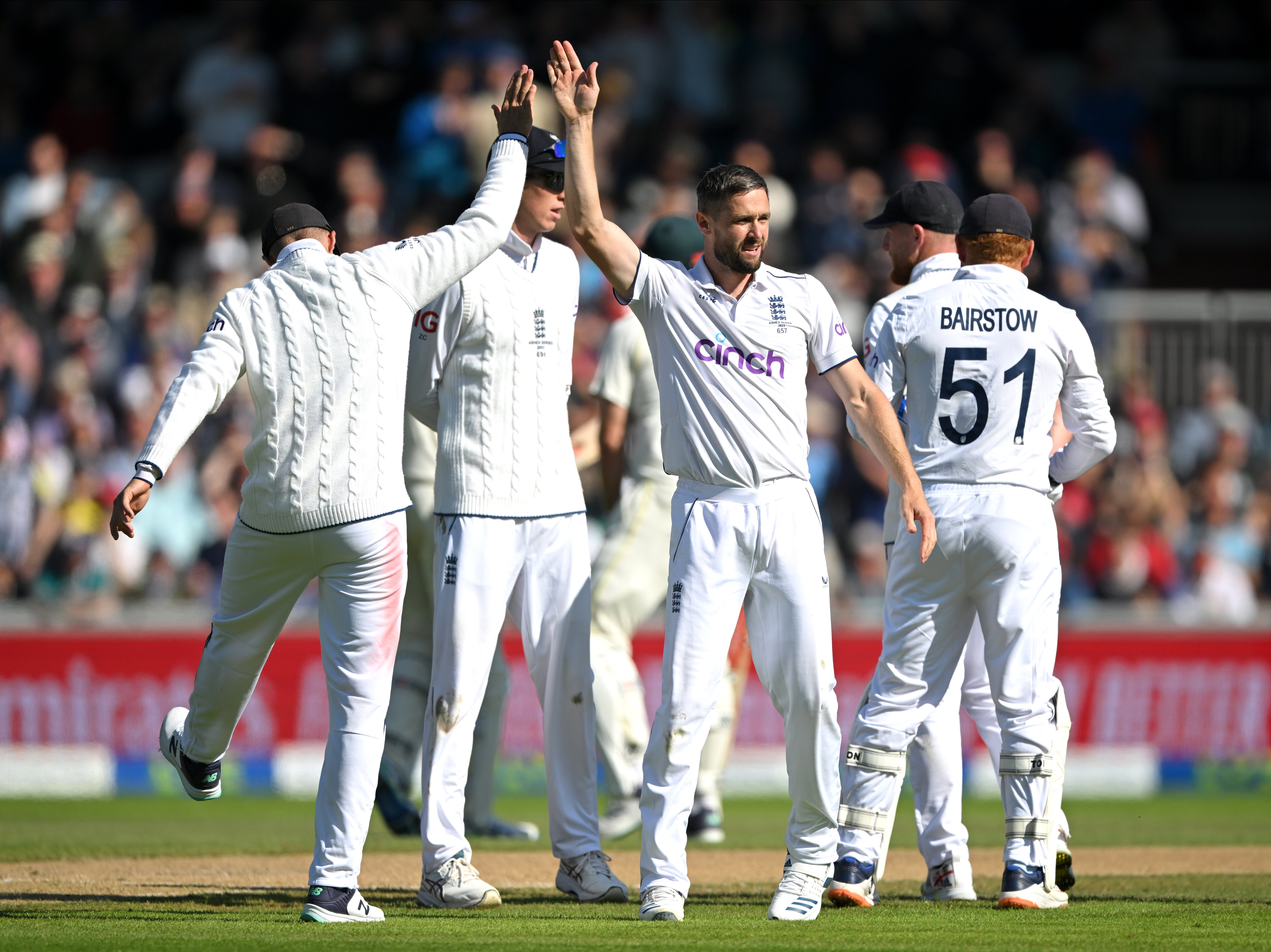 Chris Woakes celebrates with teammates on a day when he took four tickets