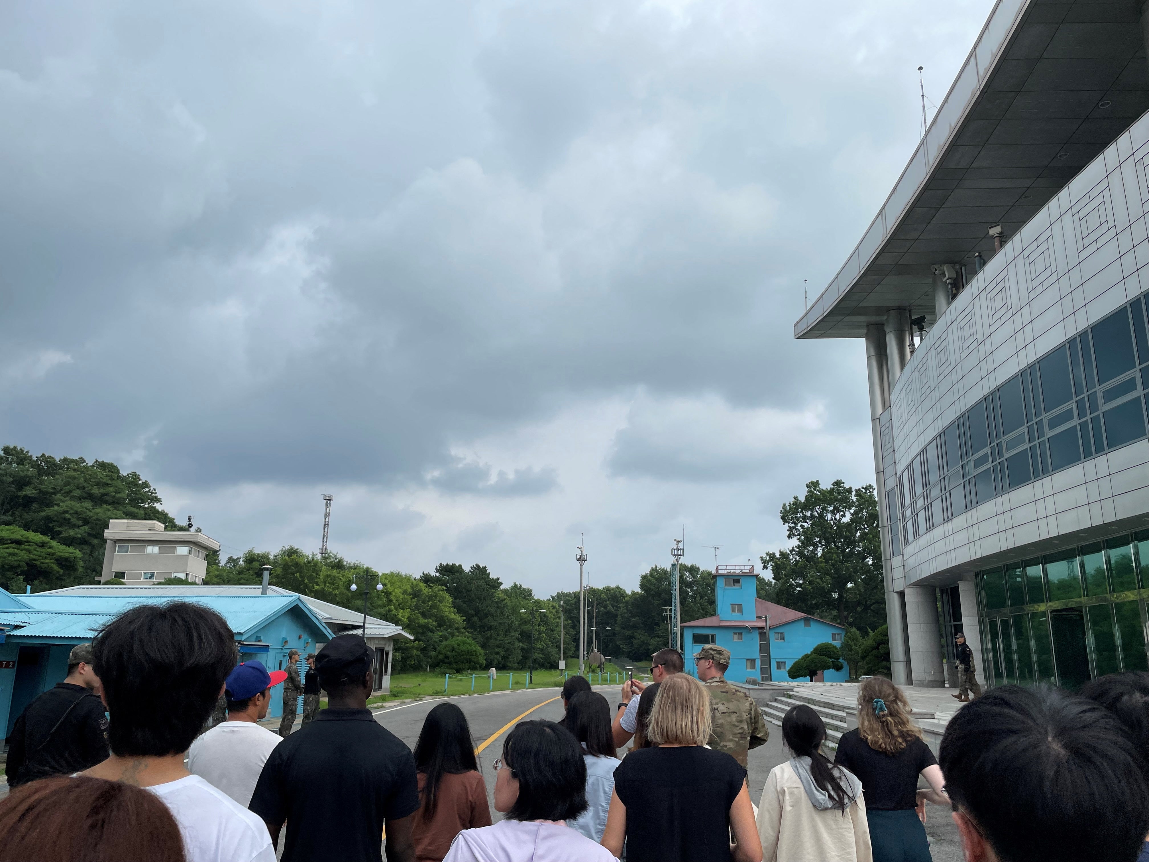 U.S. Private Travis T. King (wearing a black shirt and black cap) is seen in this picture taken during a tour of the tightly controlled Joint Security Area (JSA) on the border between the two Koreas, at the truce village of Panmunjom, South Korea, July 18, 2023