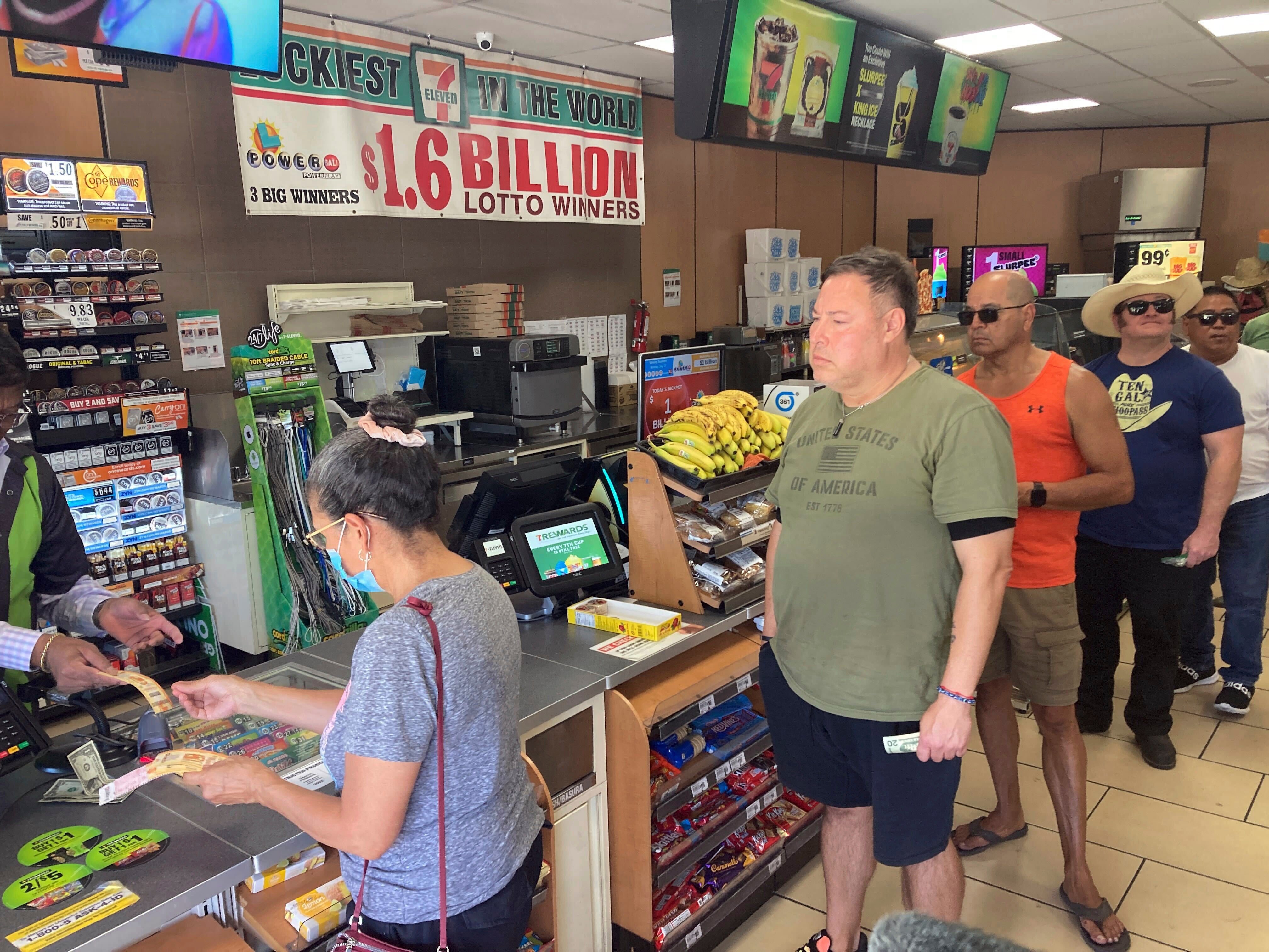 People line up to buy Powerball tickets at a 7 Eleven liquor store