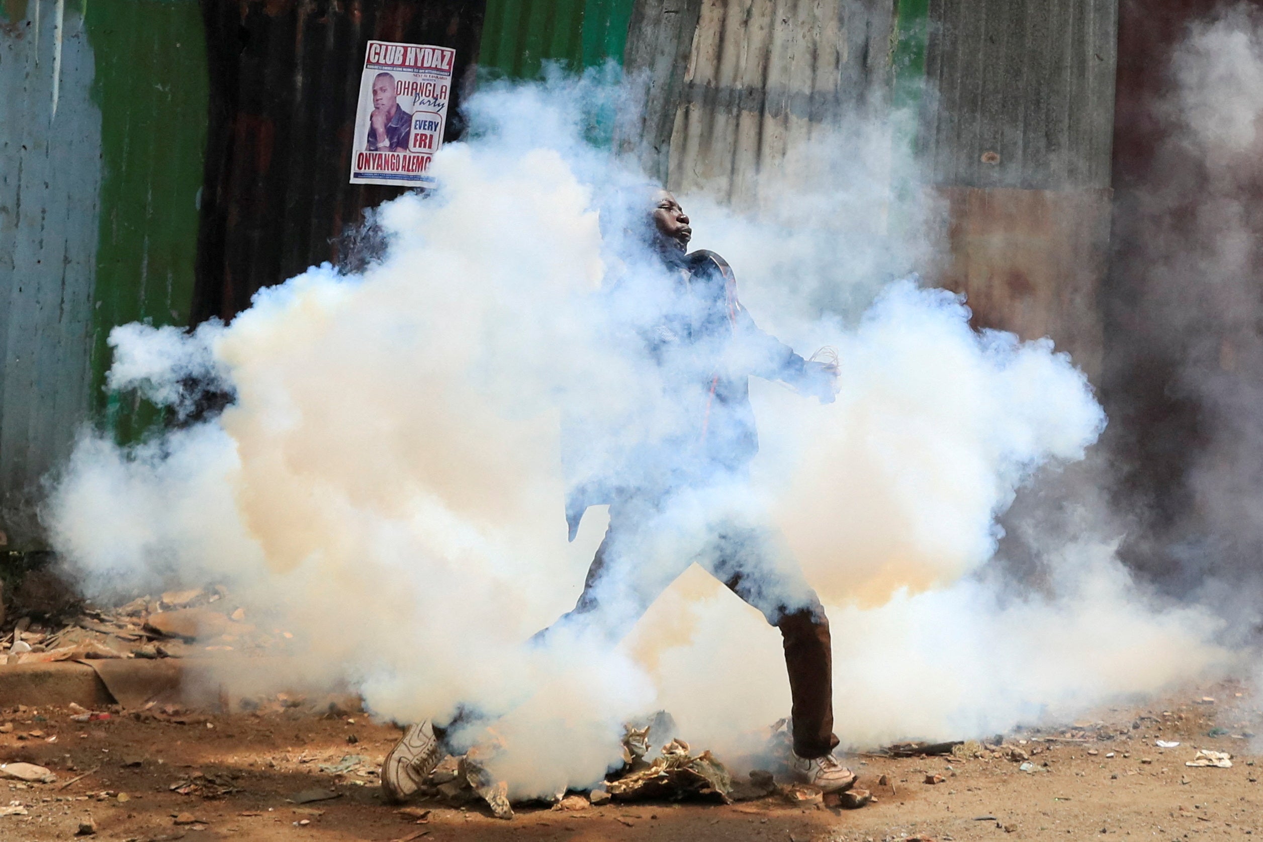 A man hurls a projectile as supporters of Kenya's opposition leader Raila Odinga of the Azimio La Umoja (Declaration of Unity) One Kenya Alliance, clash with police as they participate in an anti-government protest against the imposition of tax hikes by the government in Nairobi, Kenya