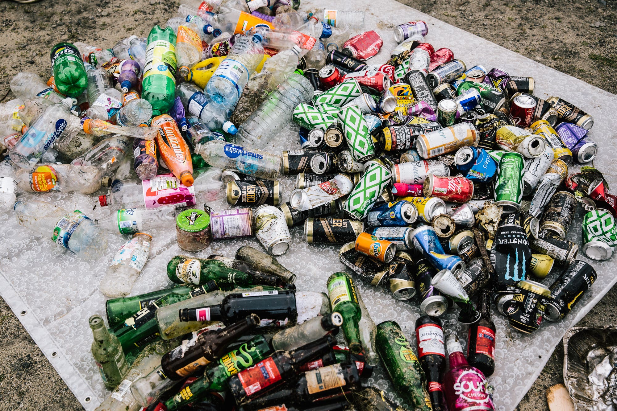 Large numbers of bottles and cans were found on a beach during a year-long collection (Ian Lean/PA)