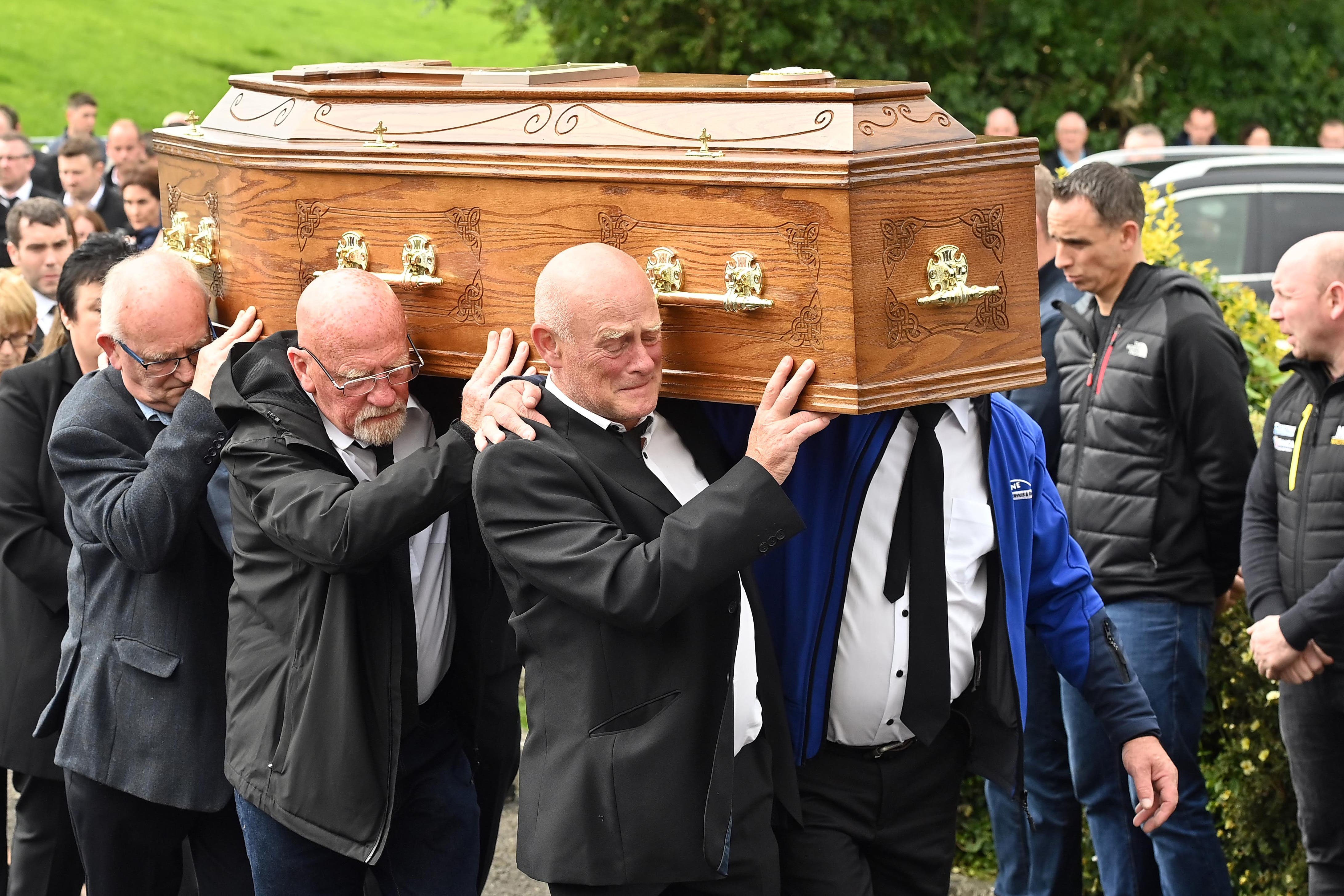 The coffin of Gene McDonald is carried into St Mary’s Church, Middle Chapel, Co Caven (Oliver McVeigh/PA)