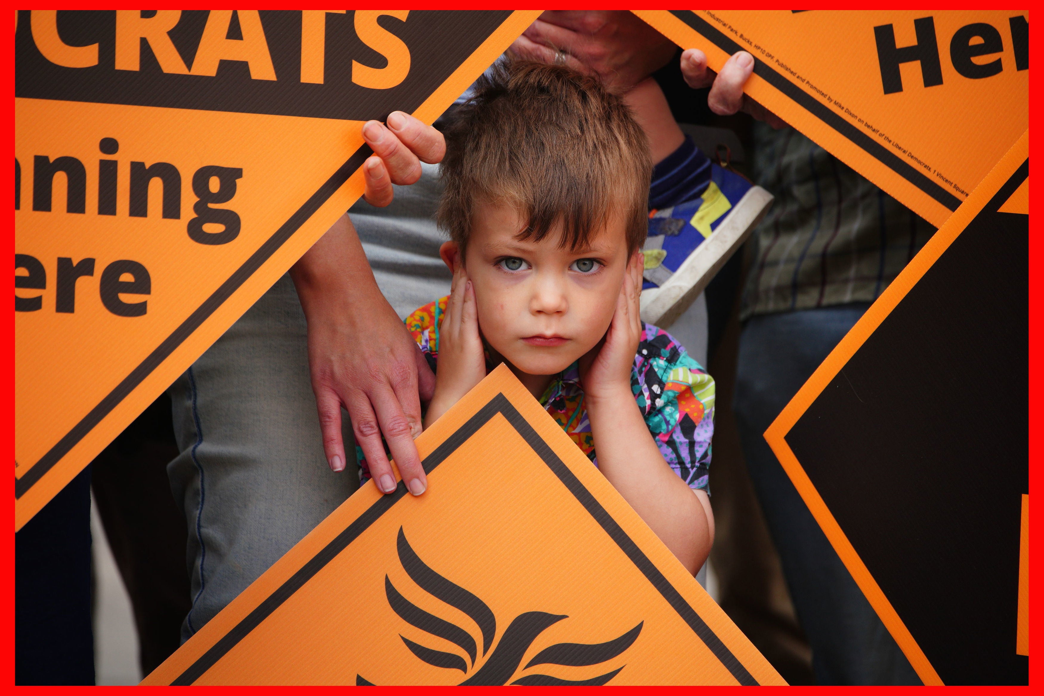 Four year old Sam Palmer-White covers his ears during the celebrations as newly elected Liberal Democrat MP Sarah Dyke meets up with party leader Sir Ed Davey in Frome