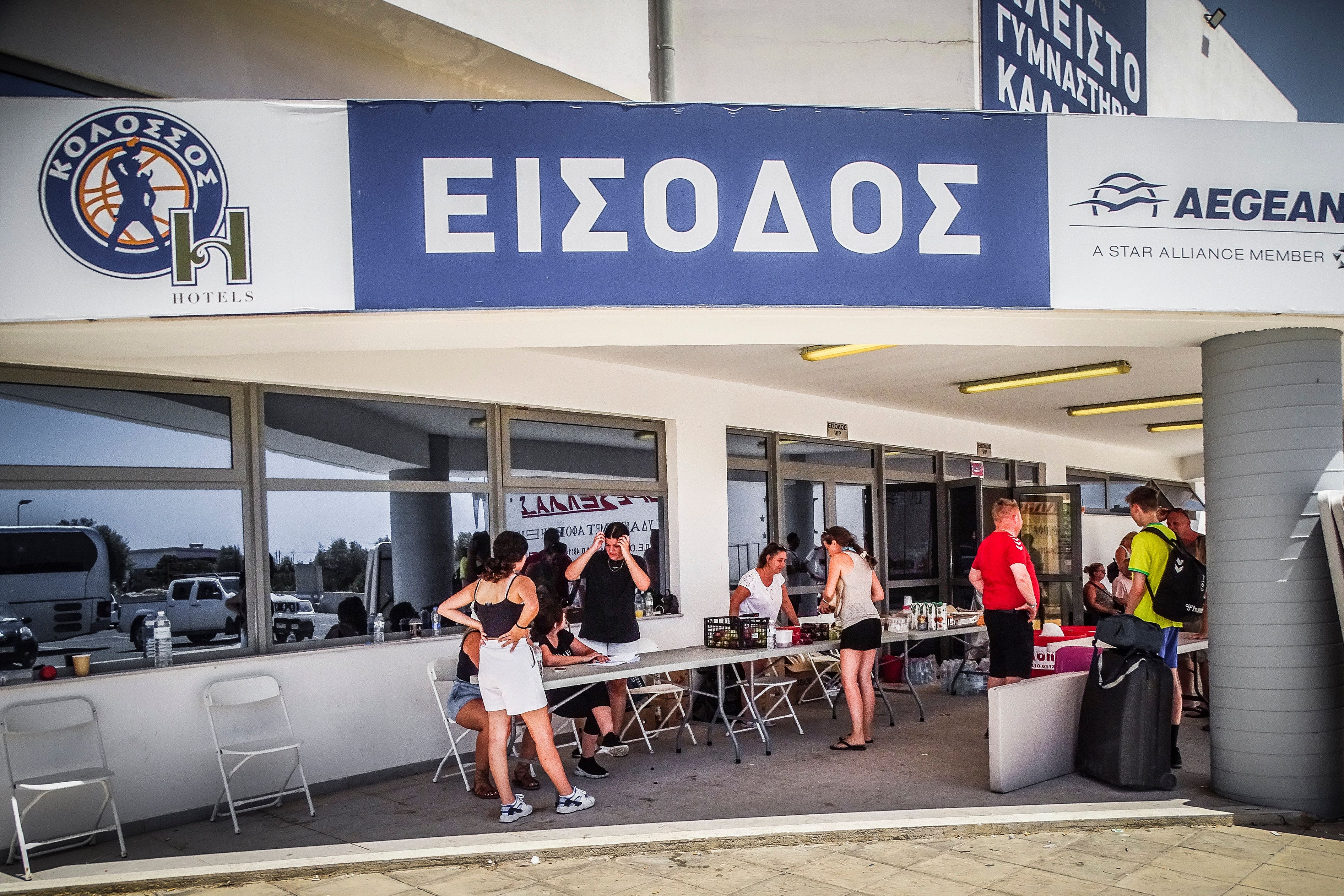 The entrance of a stadium where evacuees from a forest fire are gathered (Argyris Mantikos/AP)