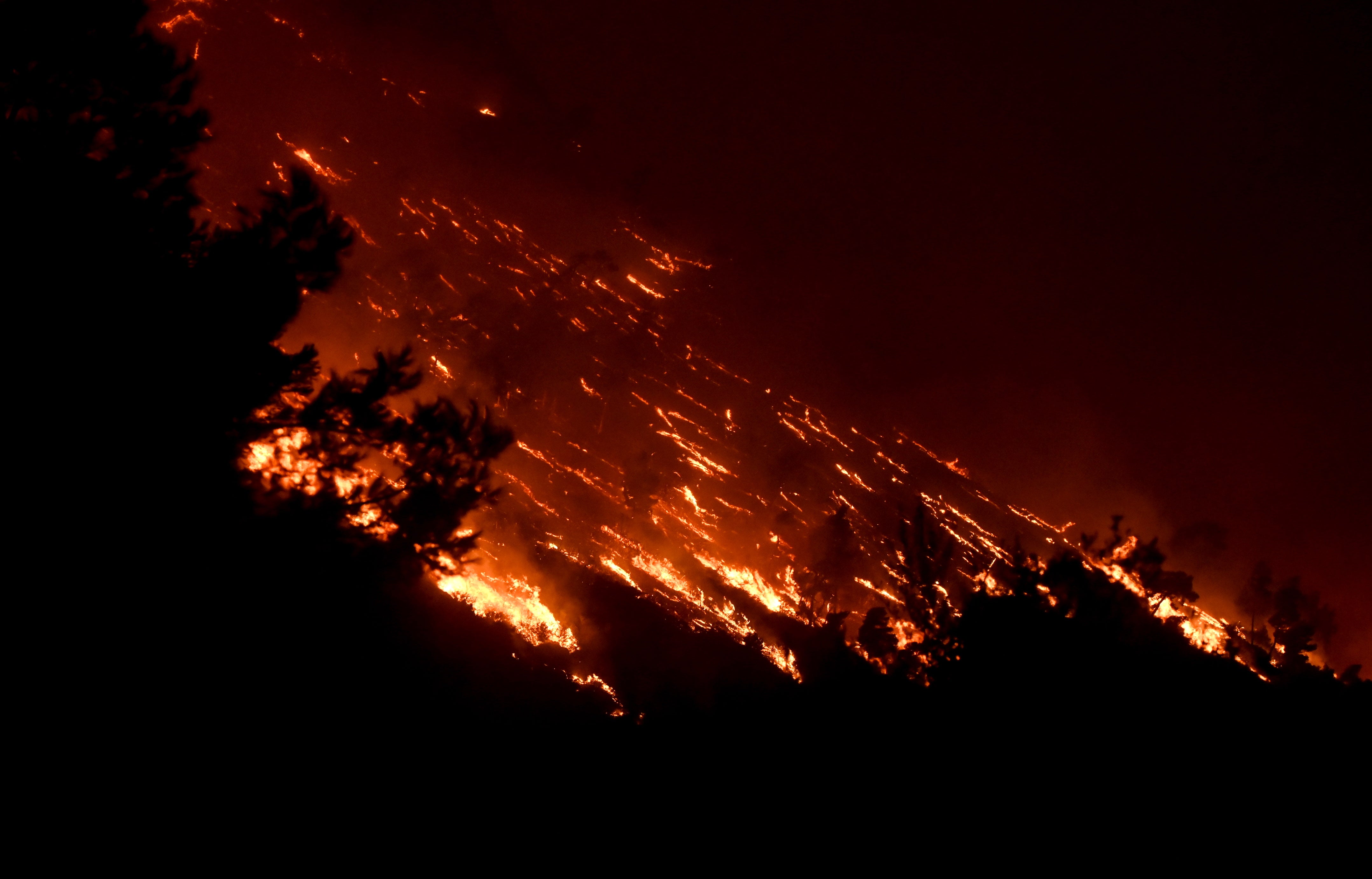 A wildfire burns at the Trapeza village in Achaia Peloponnese, Greece, in July 2023 – the hottest month on record