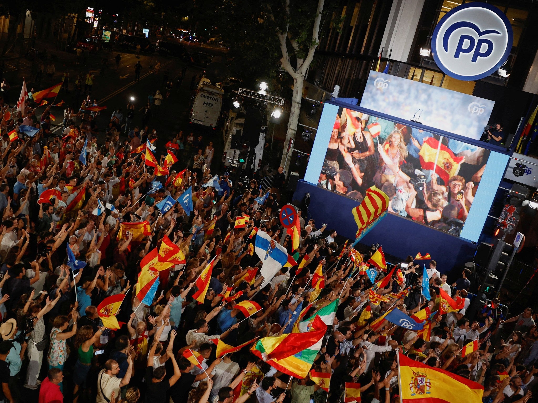 Supporters of Spain’s conservative opposition People’s Party await results outside the party’s headquarters