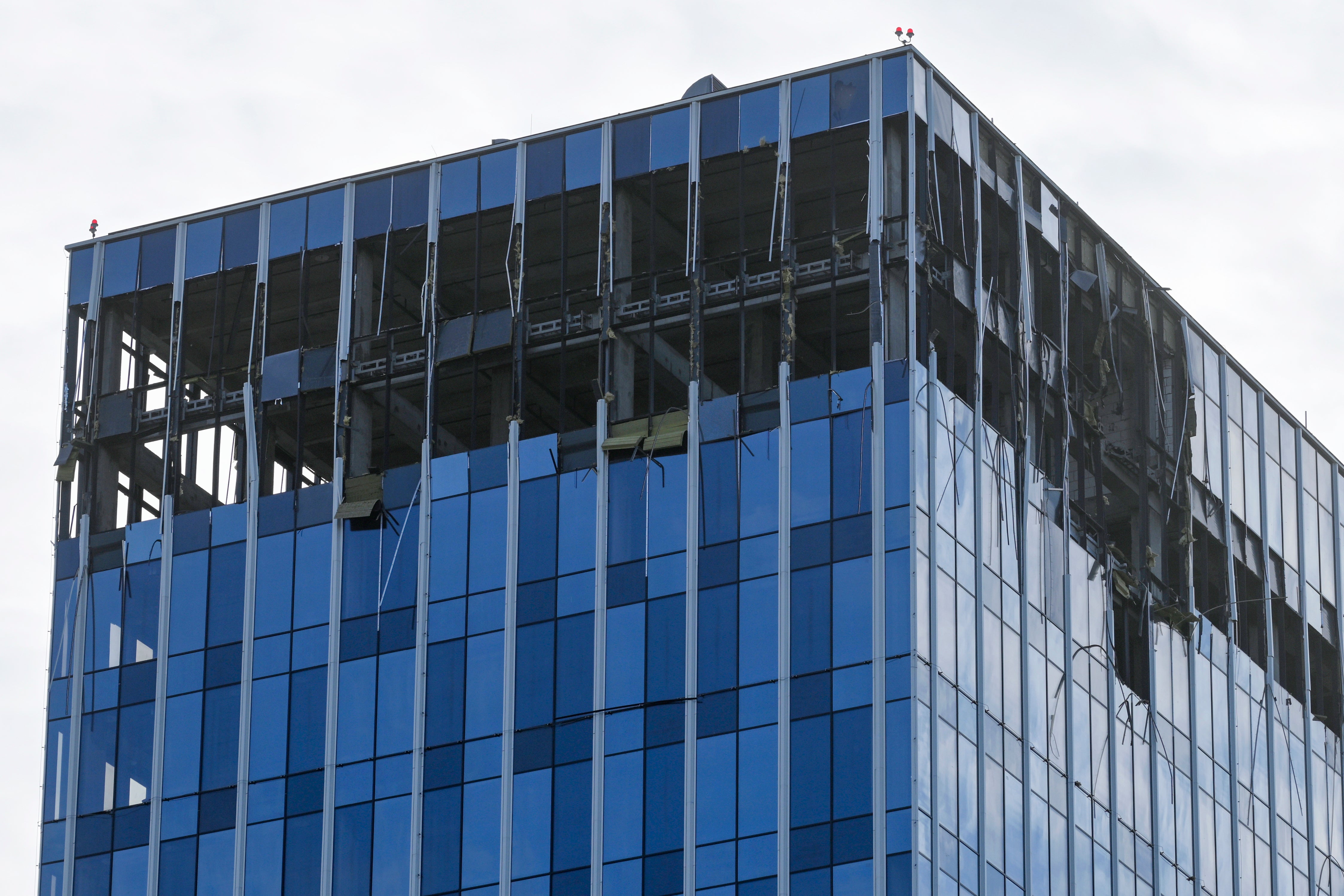 Damage to the upper floors of a Moscow building is seen after a reported drone attack on Monday morning