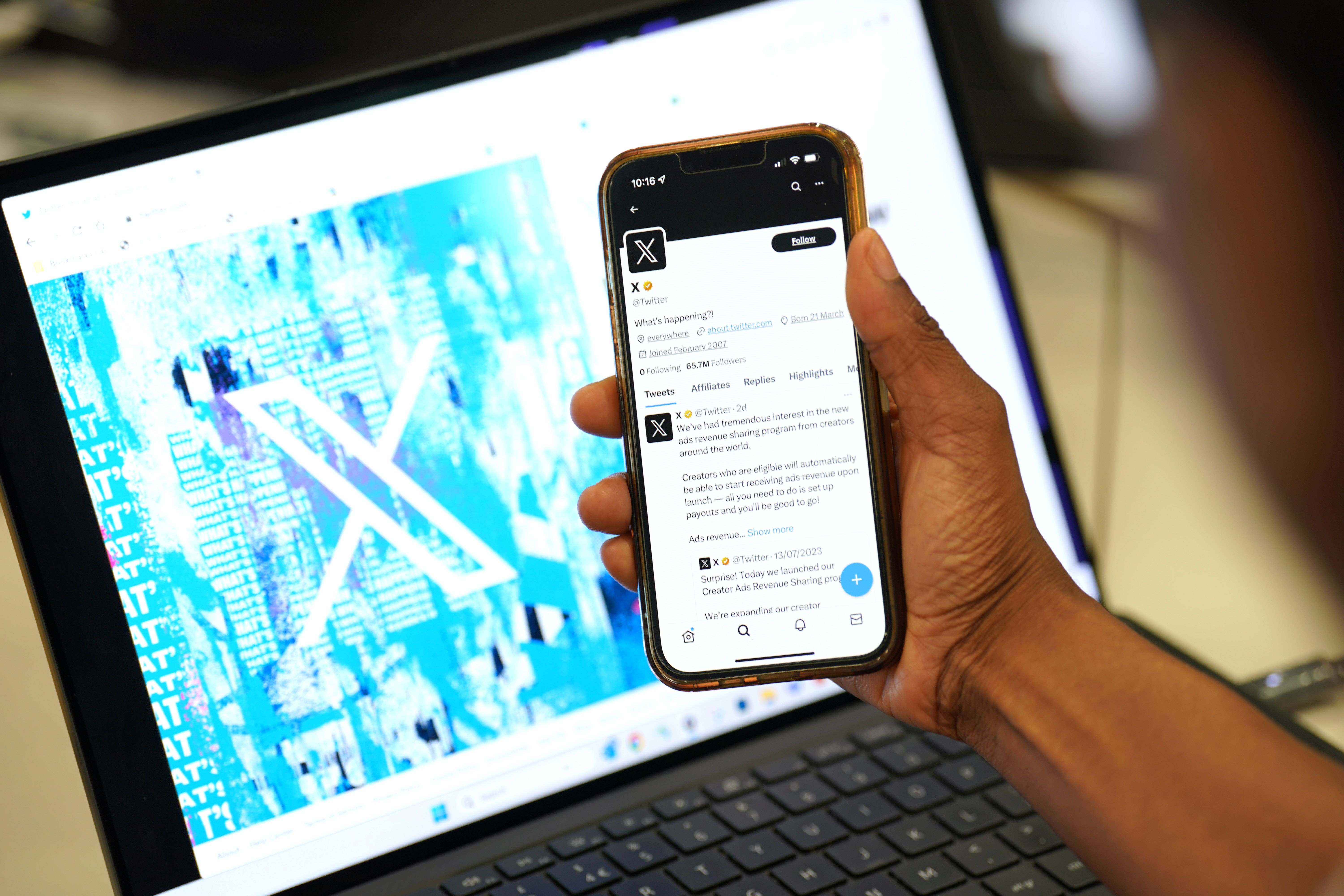 A person looks at the new logo for Twitter on an Apple iPhone in an office in London (Jonathan Brady/PA)