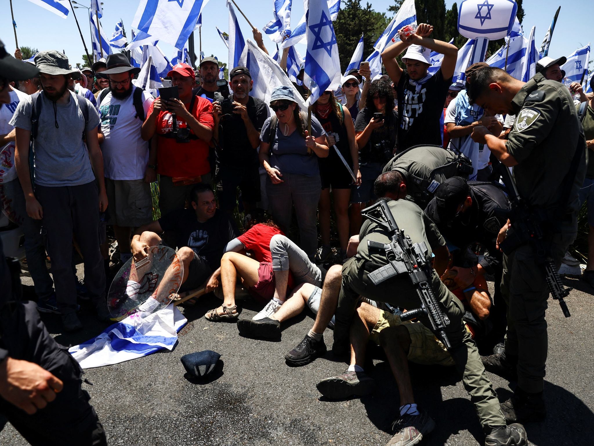 Israeli police detain a protester during a demonstration against the bill in Jerusalem