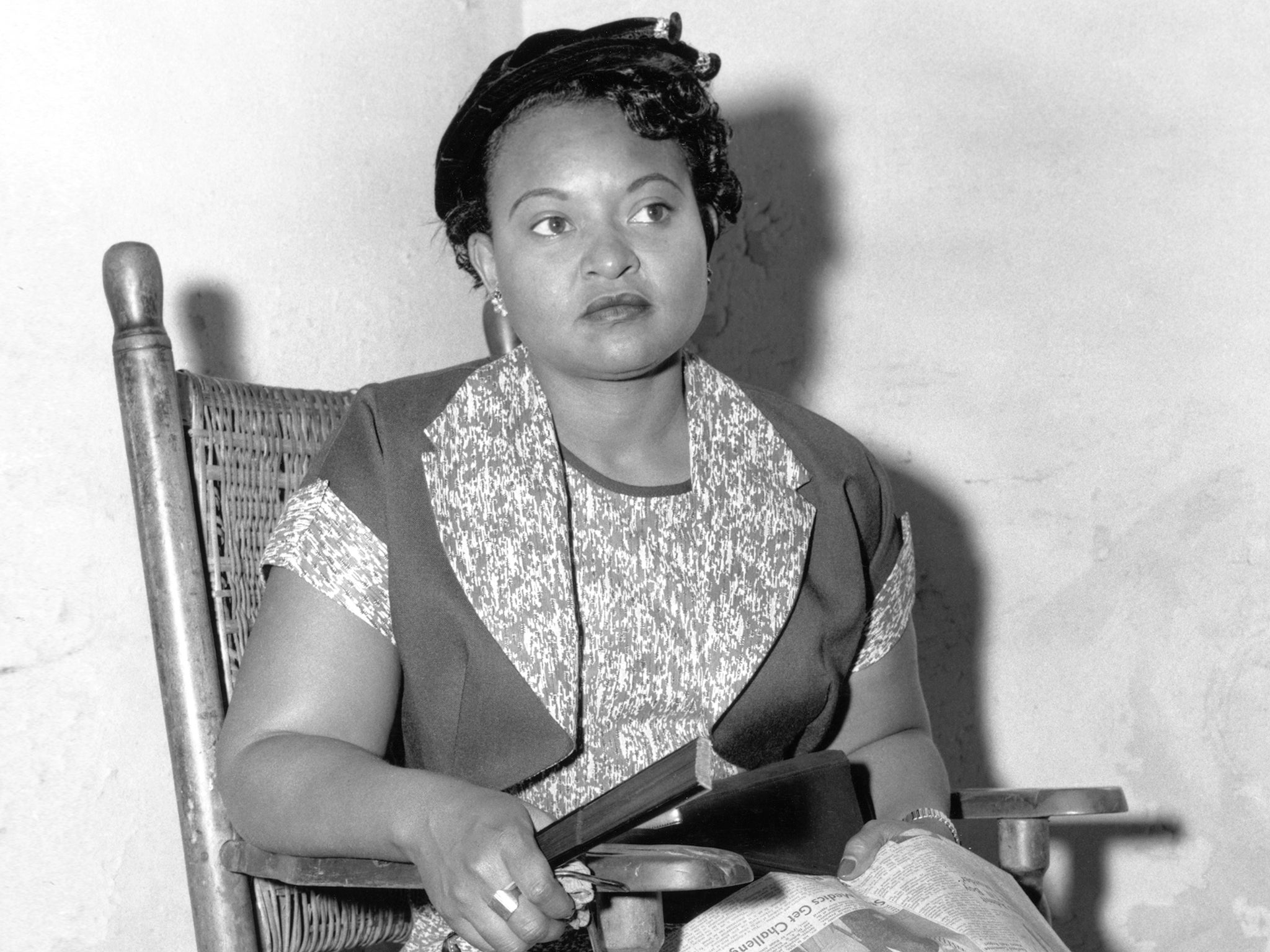 American civil rights activist Mamie Till (1921-2003), the mother of Emmett Till, sitting with a copy of the Clarion-Ledger newspaper on her lap, in Sumner, Mississippi, 22nd September 1955.