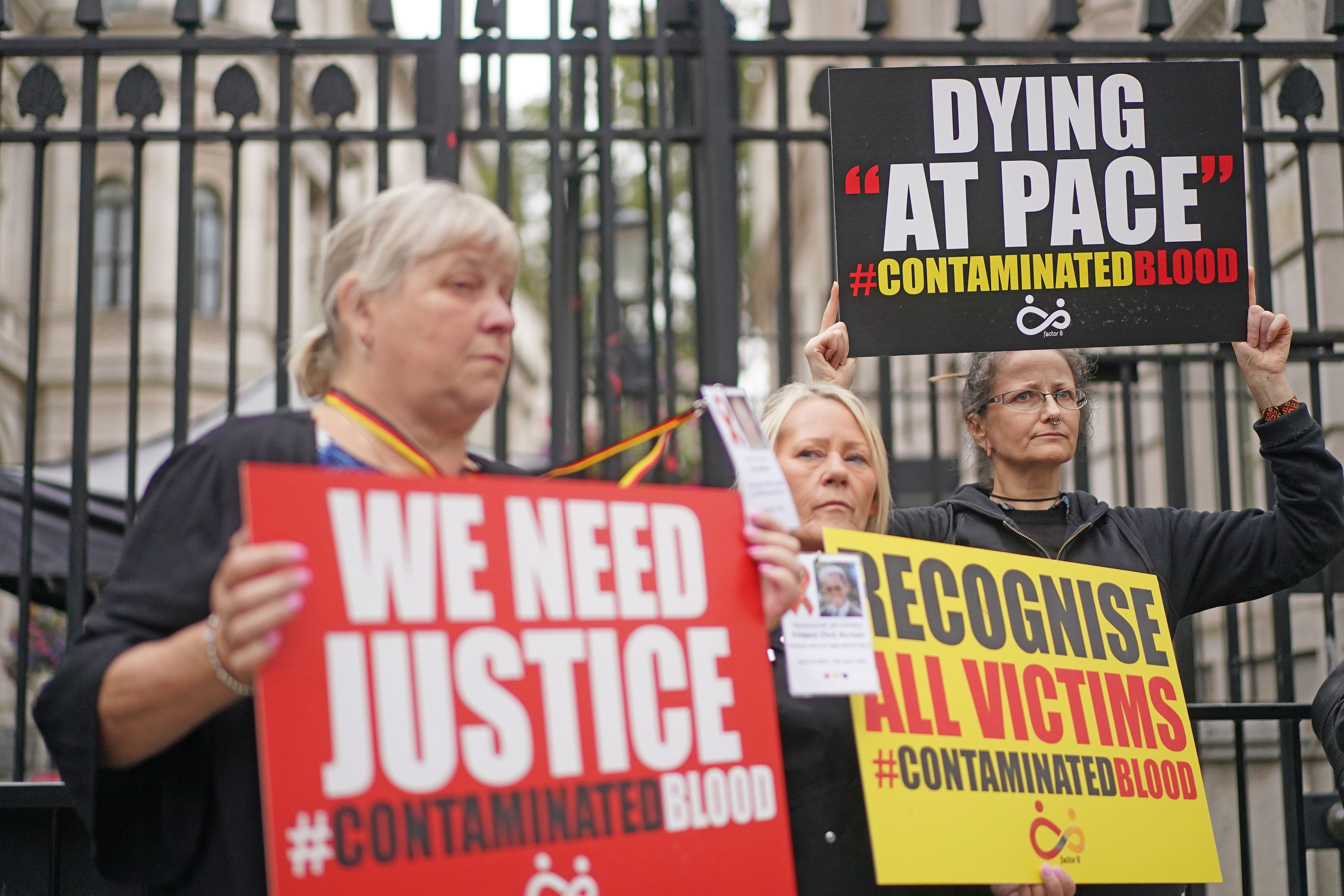 Relatives demonstrate outside No 10 (Victoria Jones/PA)