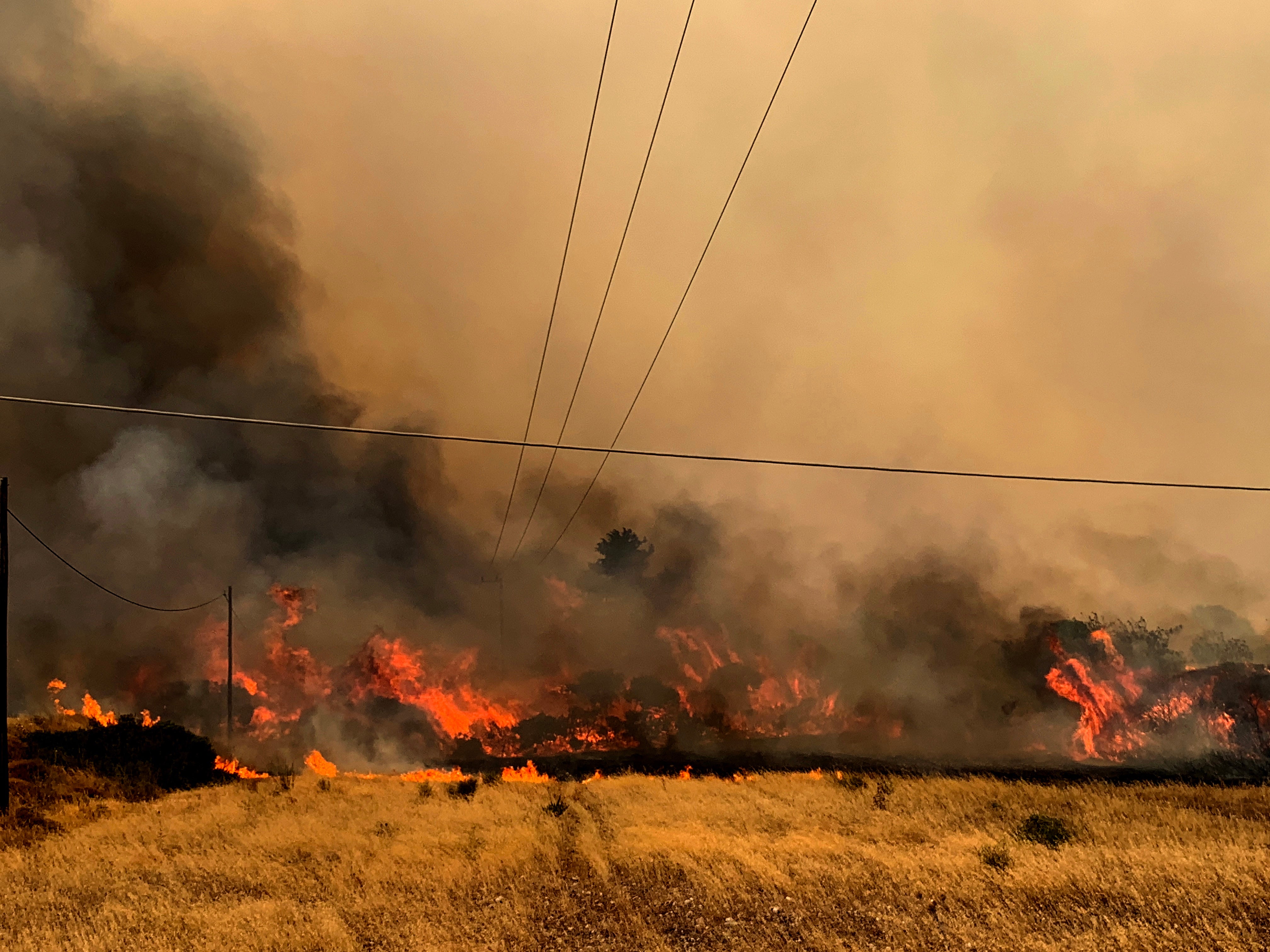 A fire burns trees and low vegetation in the Kiotari area of Rhodes