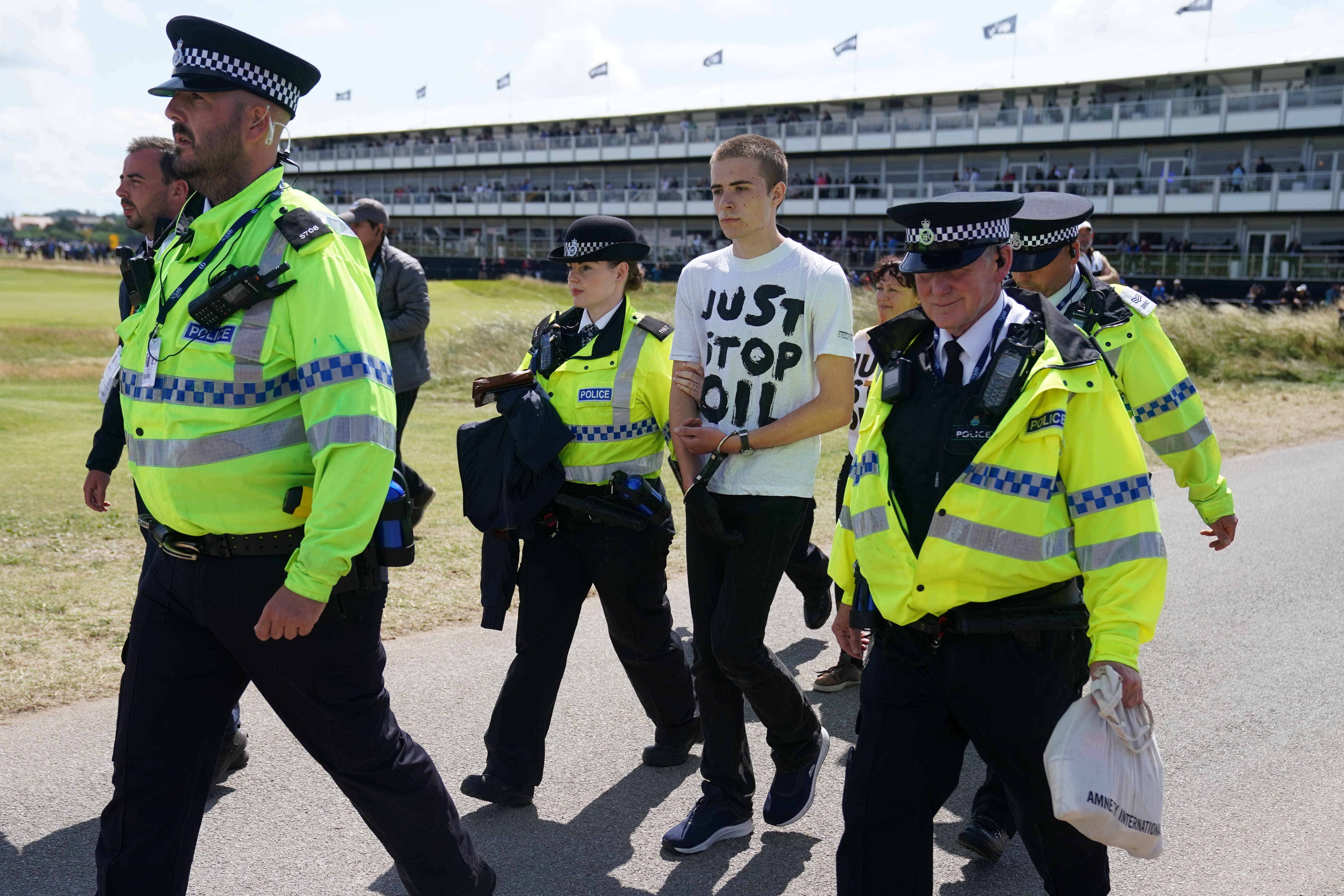 A Just Stop Oil protester is taken away by Police during day two of The Open (David Davies/PA)