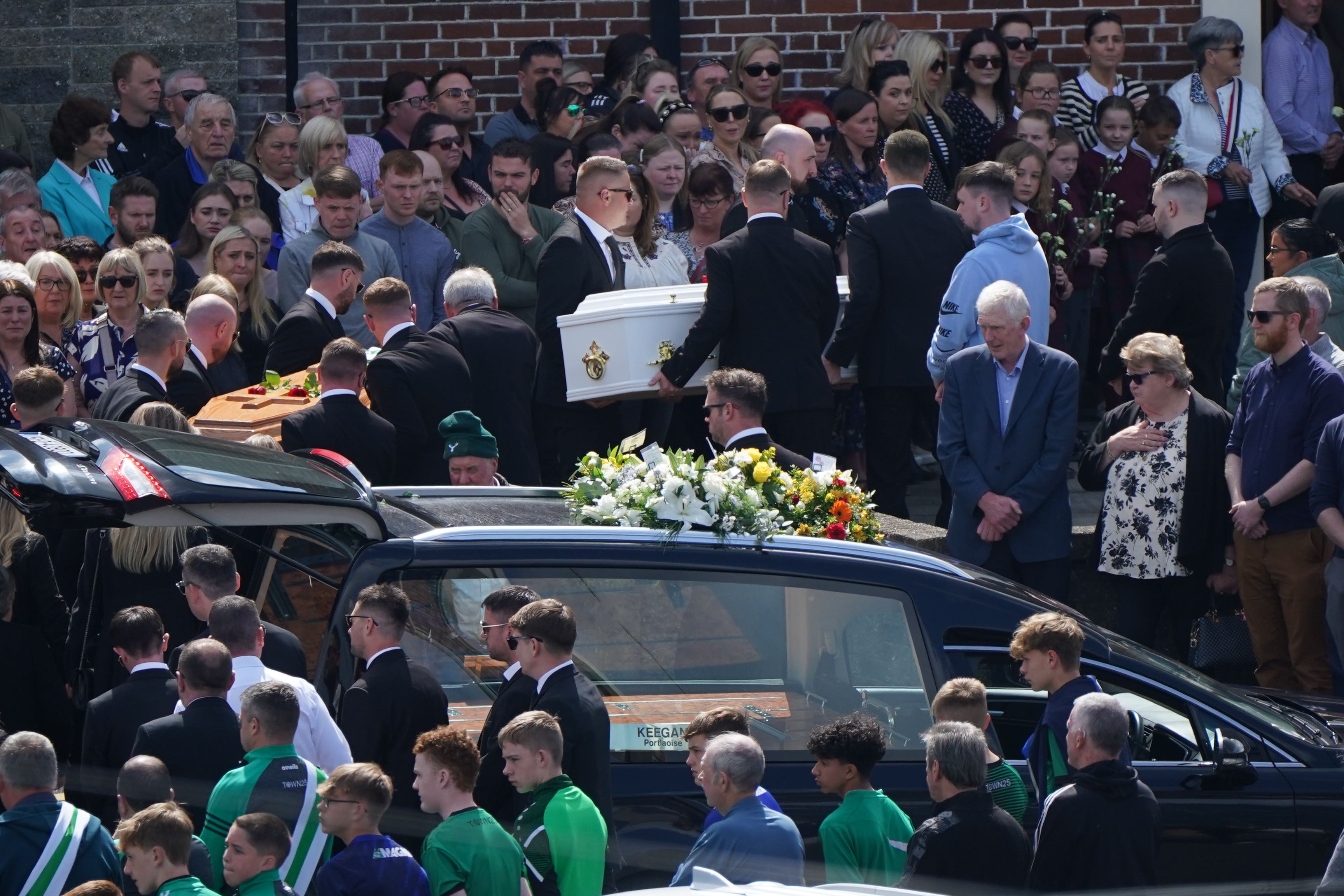 The coffins of father and son Eoin and Dylan Fitzpatrick are carried into their funeral service (Niall Carson/PA)