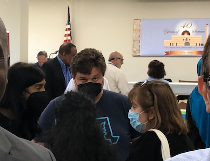 Lieutenant Governor Aruna Miller is seen speaking with two Peace Action Montgomery volunteers while a Moore campaign staffer stares at the camera.