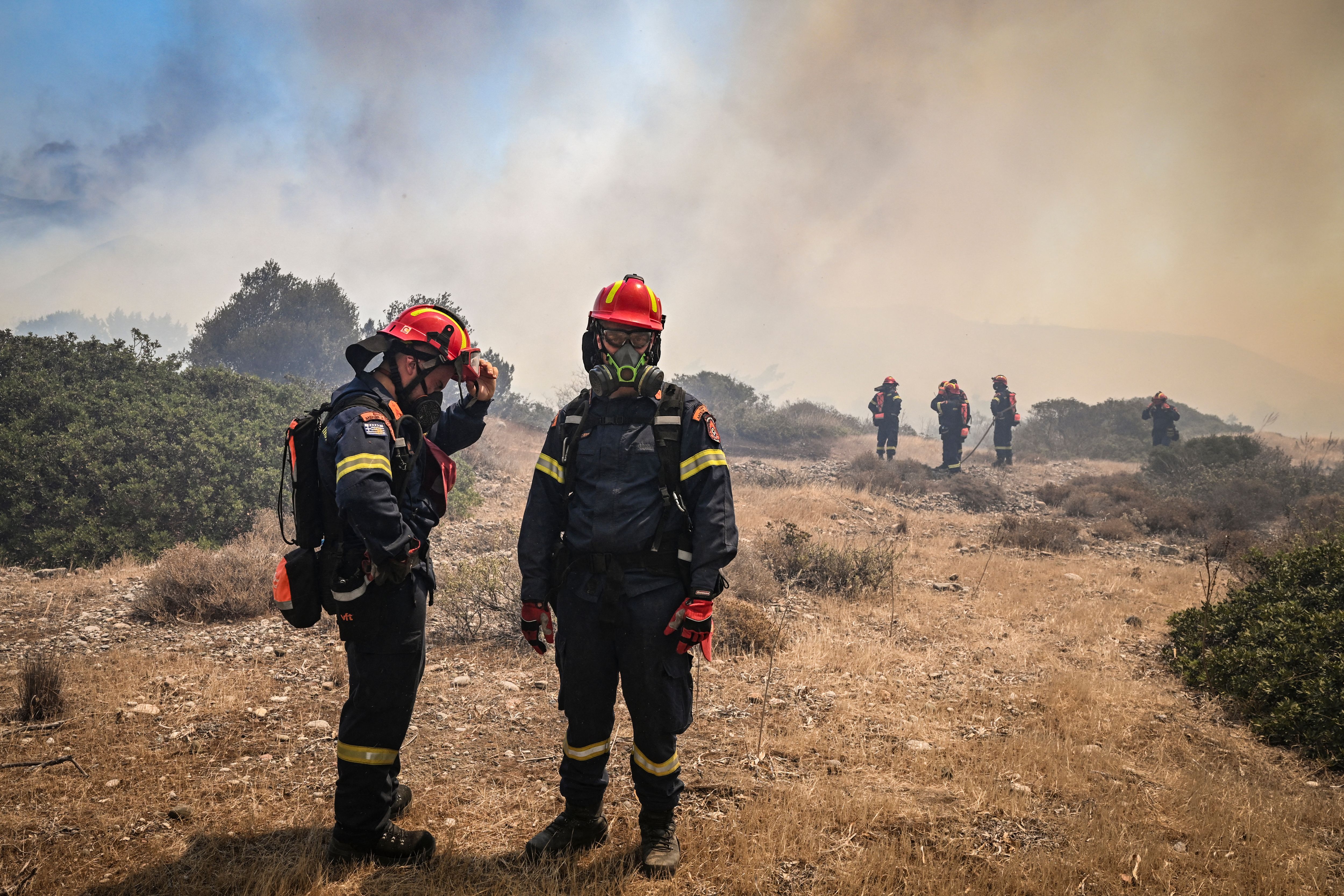 Greek firefighters work to extinguish wildfires near Vati