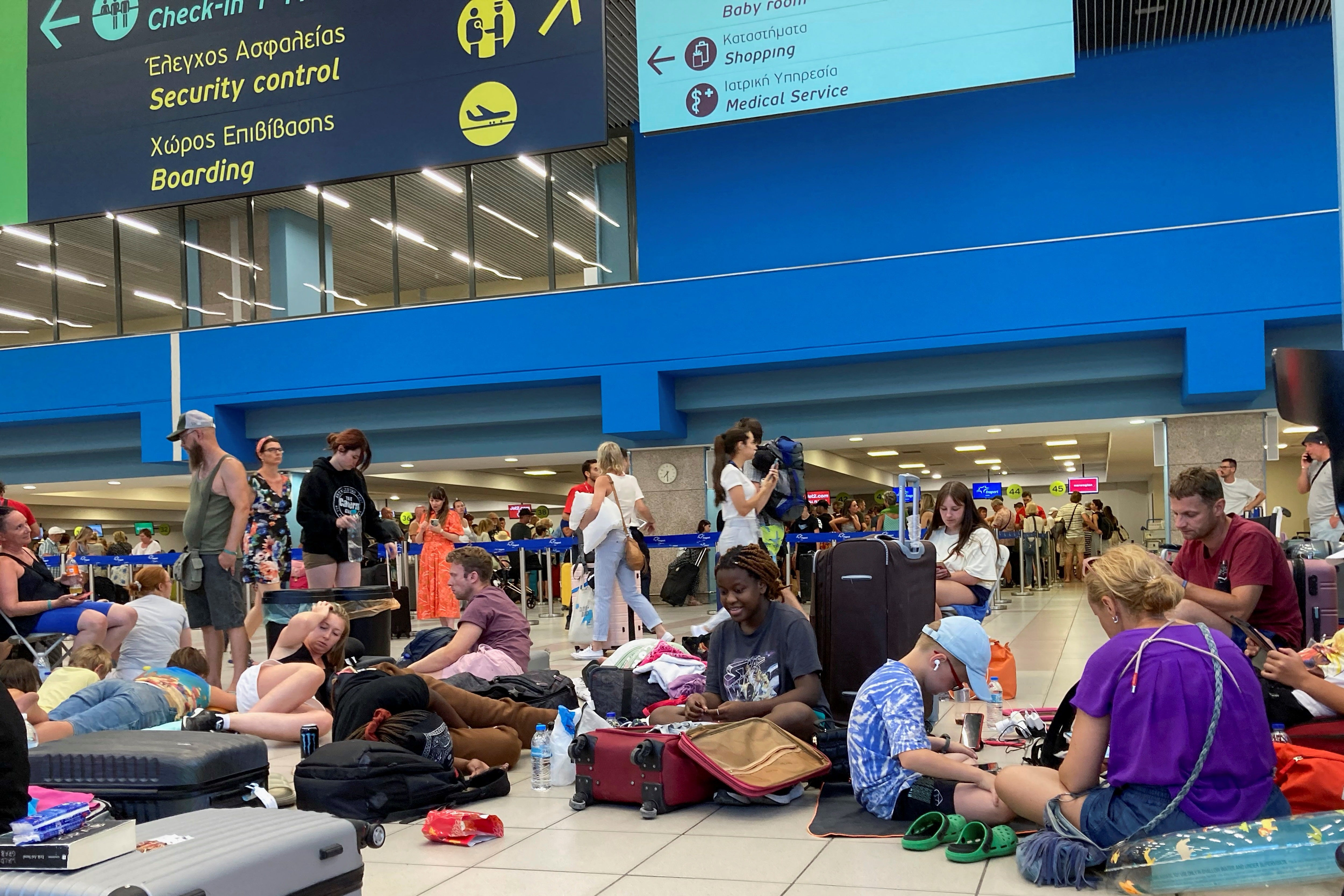 Travellers wait at the airport during evacuations