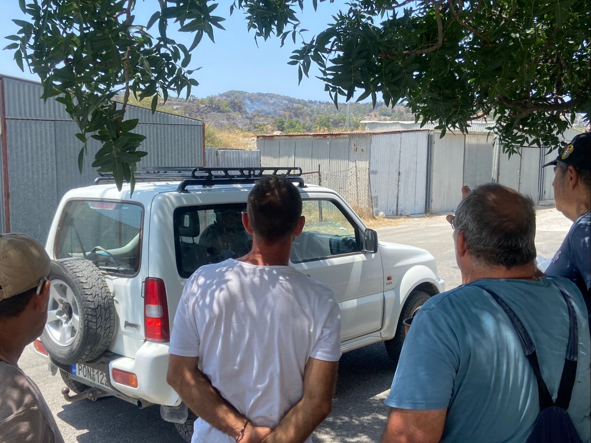 Volunteers watch on as a flare-up reignites near Malonas