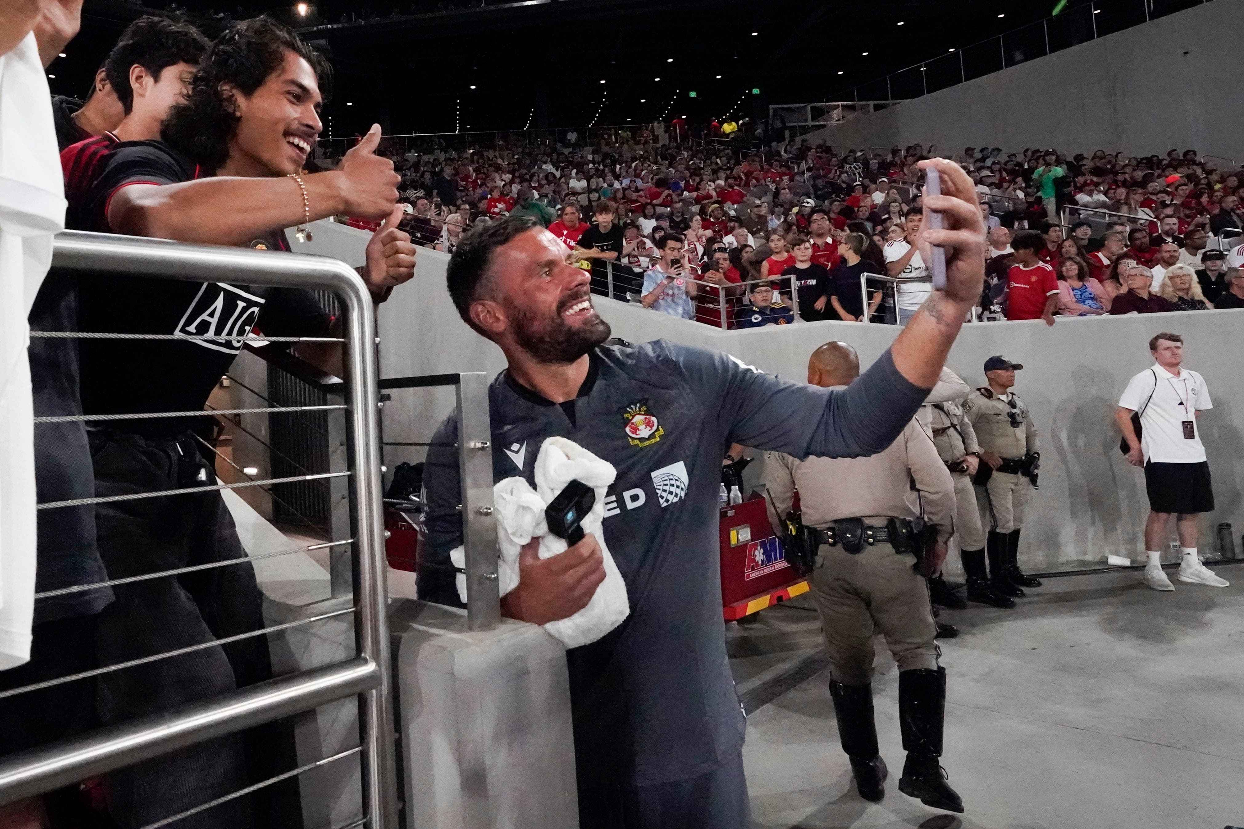 Wrexham goalkeeper Ben Foster poses for a photo with fans in San Diego (AP Photo/Gregory Bull)