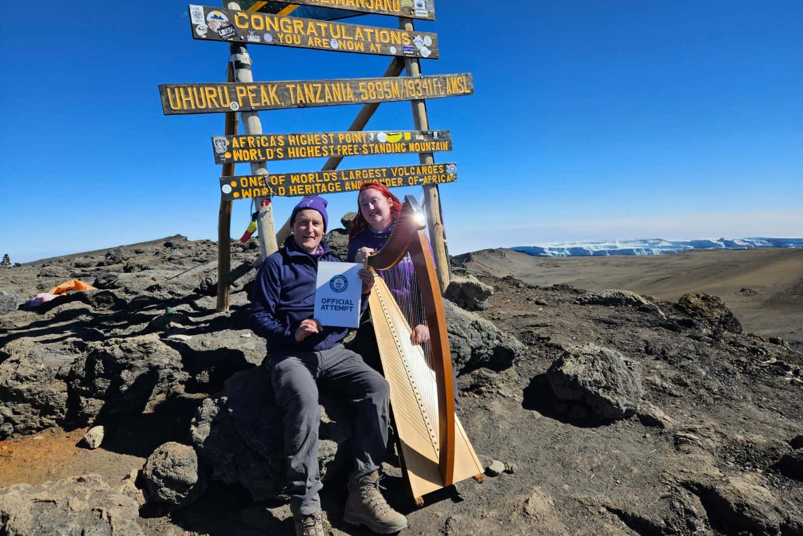 Siobhan Brady (right) with her harp on Mount Kilimanjaro as she attempts to break the world record for highest altitude harp performance (The Highest Harp Concert Team/PA