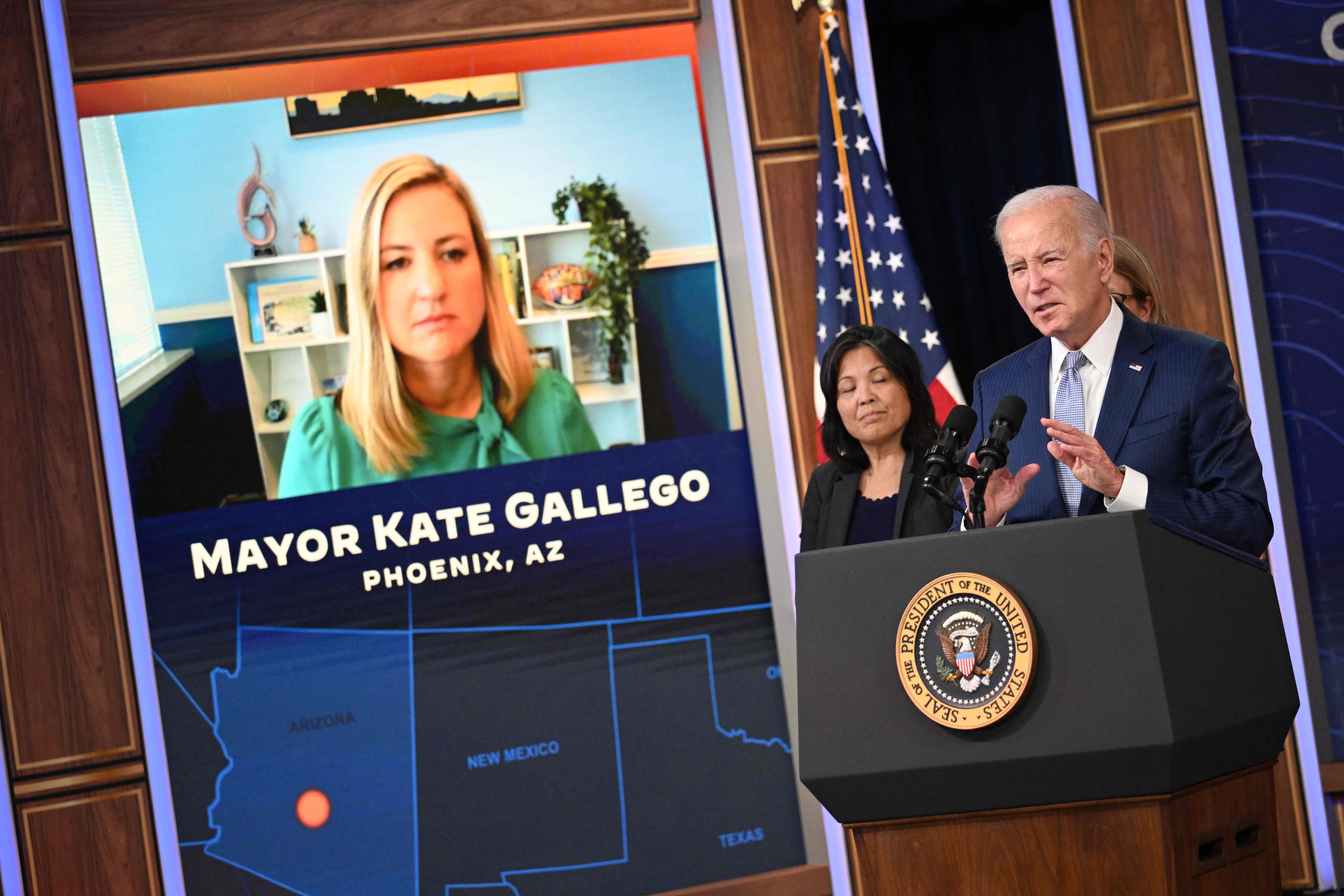 President Joe Biden, joined virtually by Phoenix, Arizona, Mayor Kate Gallego and acting Labor Secretary Julie Su (C), speaks during a briefing on extreme heat conditions at the White House on Thursday