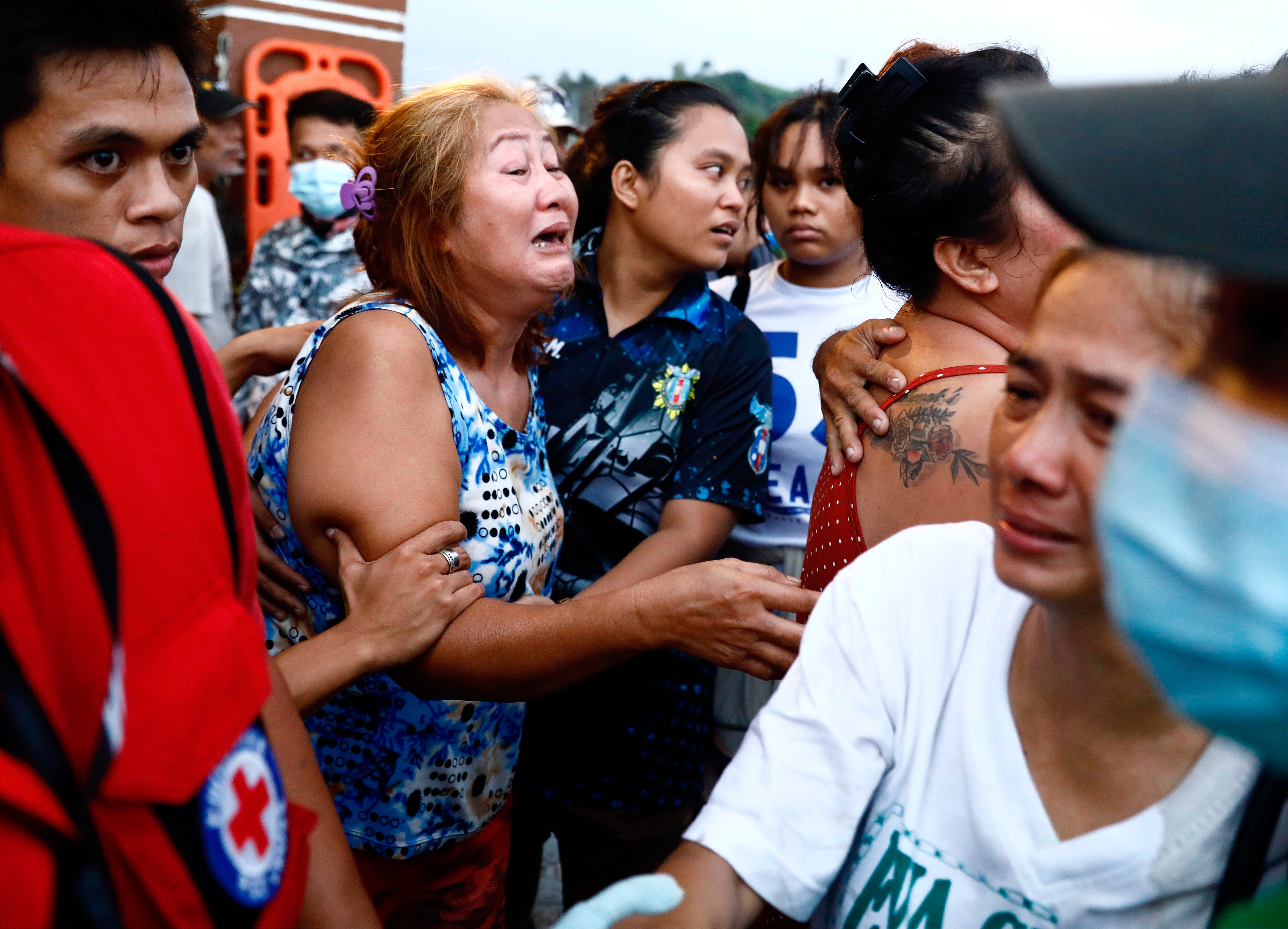 Relatives of a victim of typhoon react at the Binangonan port, Rizal province