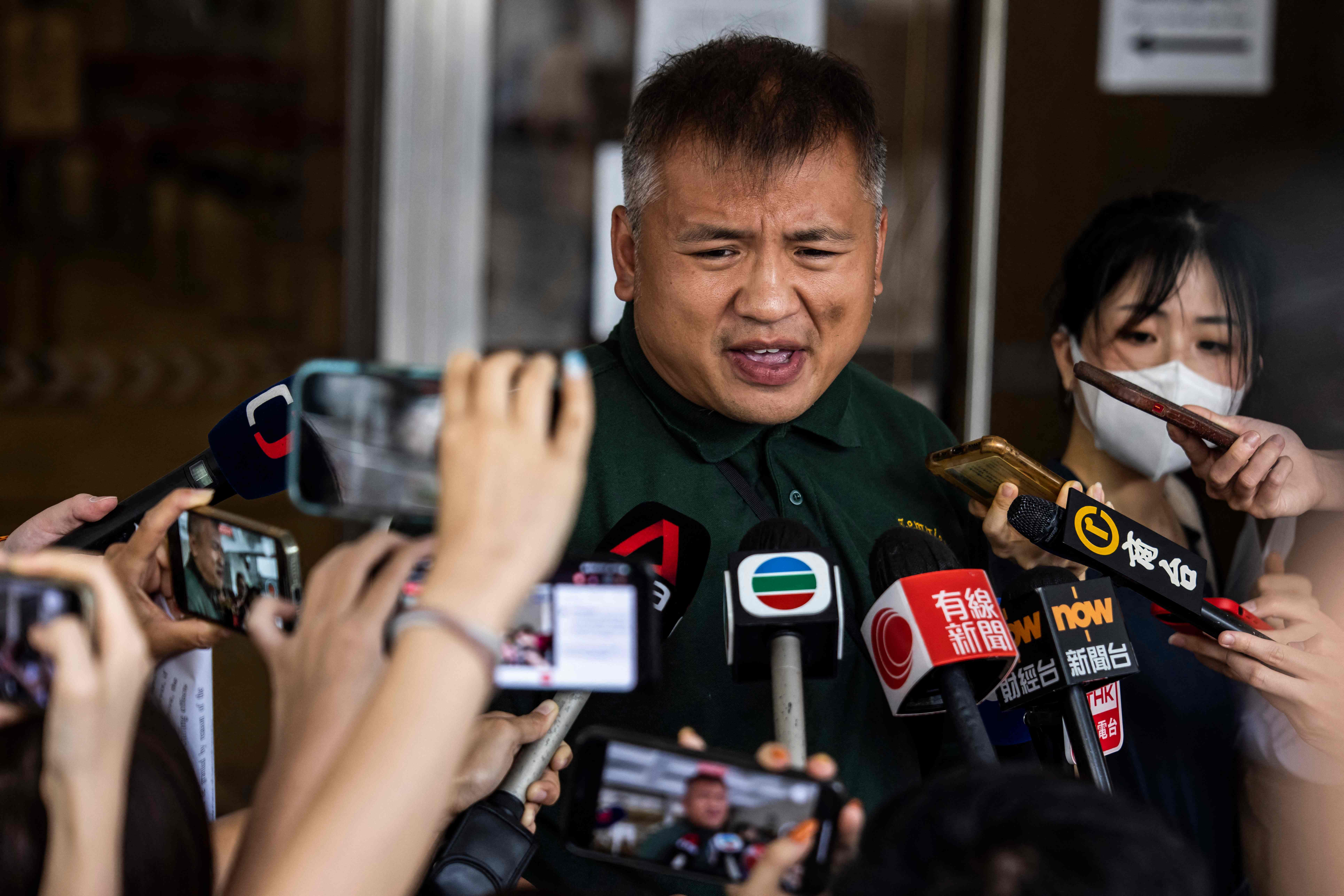 Ronson Chan (C), journalist and chairman of the Hong Kong Journalists Association speaks with the media outside the High Court in Hong Kong