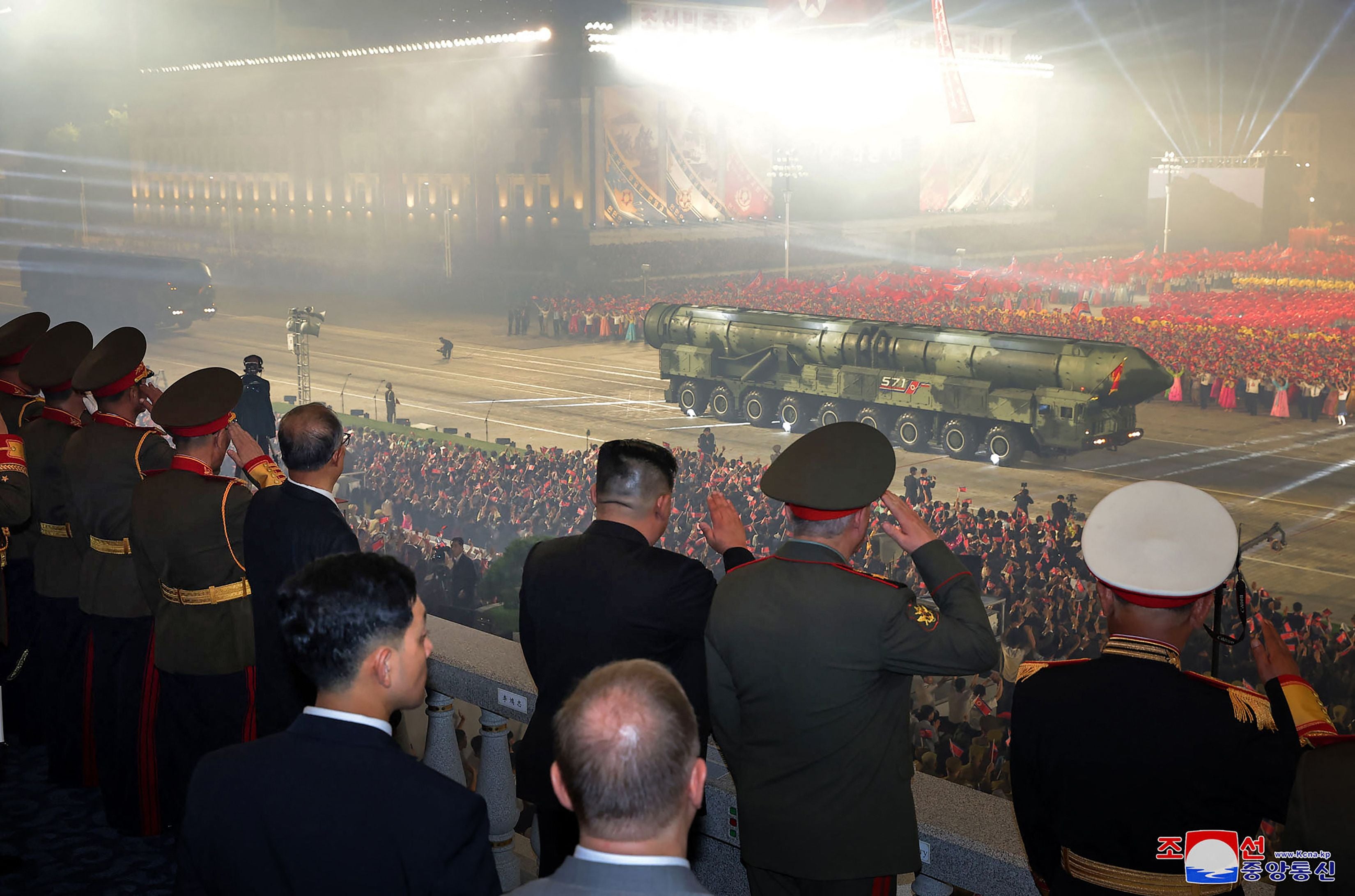 North Korea’s leader Kim Jong-n (C in black suit) watching as the new model of intercontinental ballistic missile (ICBM), the solid-fuel Hwasong-18, goes past in a military parade