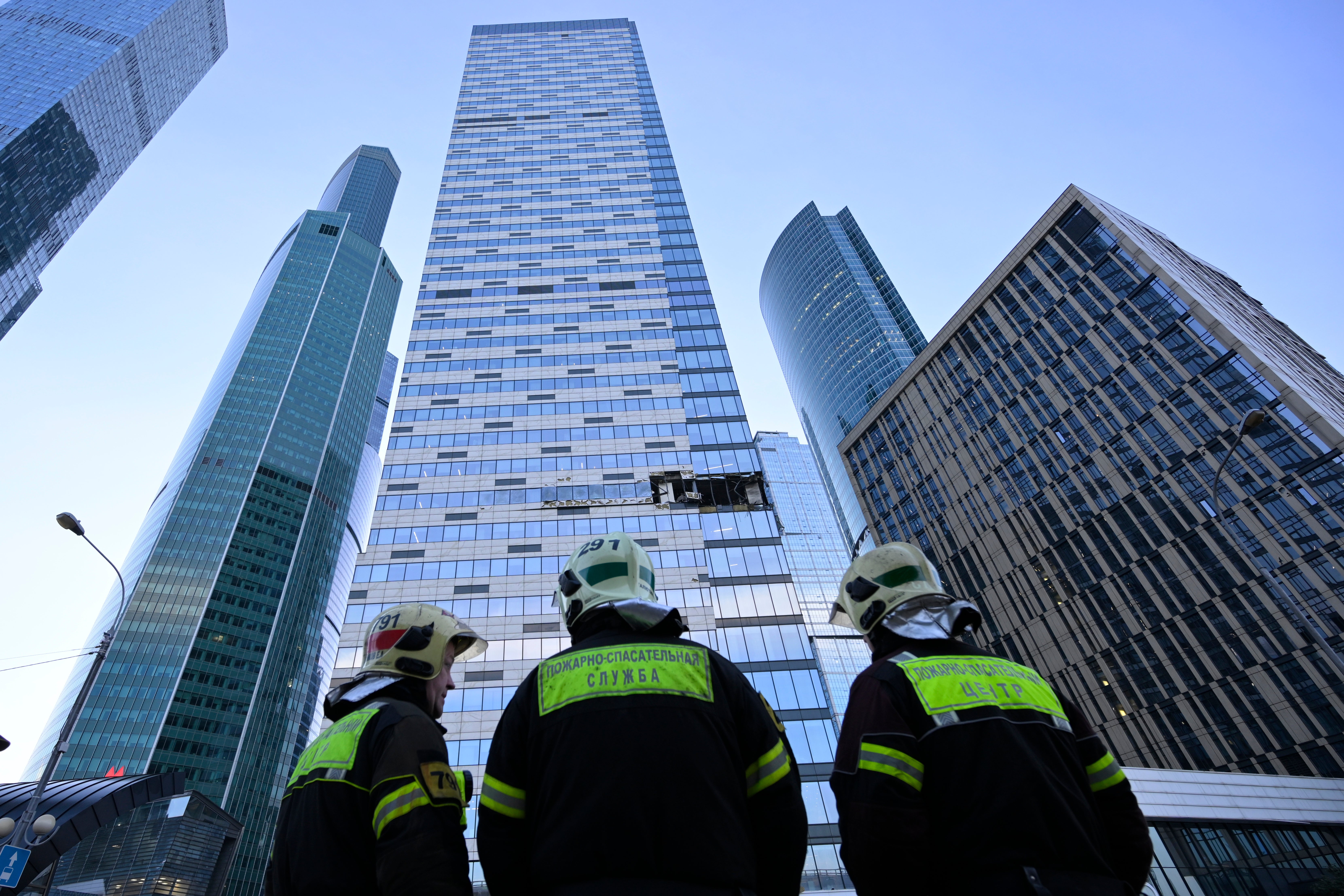 Emergency personnel survey the damage caused by one of the destroyed drones in Moscow