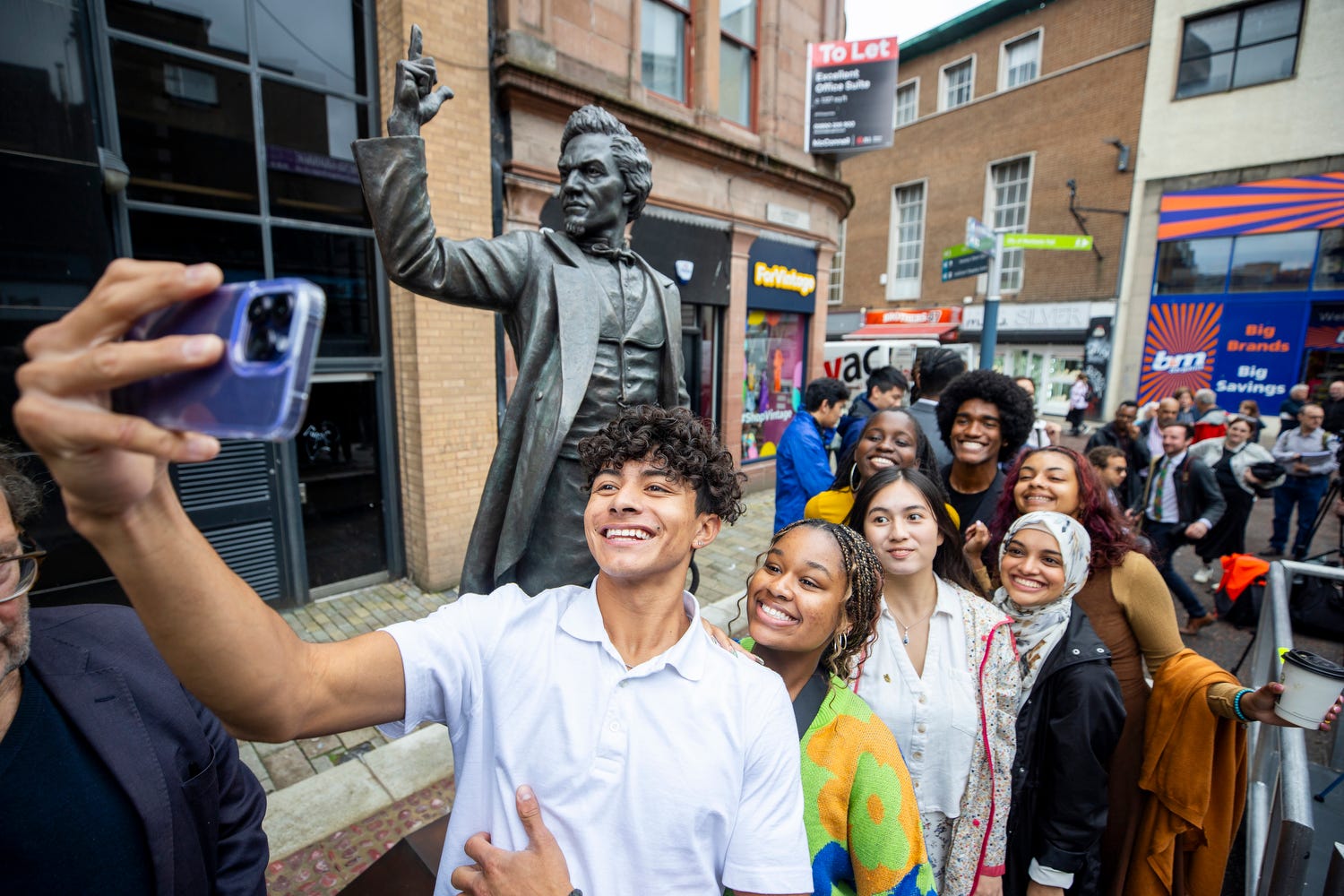 Students from the Frederick Douglass Global Fellowship at the unveiling of a statue of Frederick Douglass in Belfast city centre (Liam McBurney/PA)