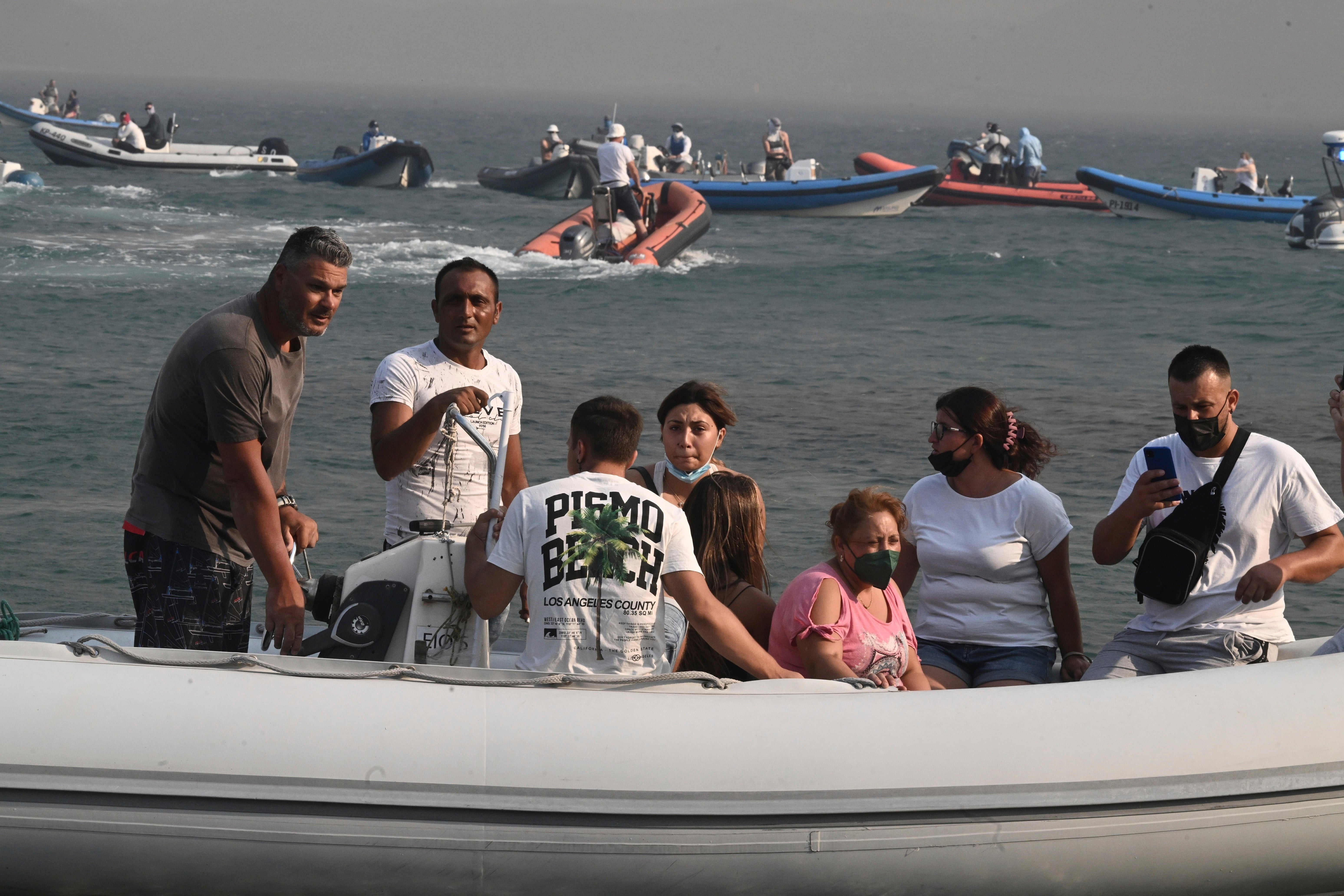 Boats arrive to help the evacuation of residents and tourists from the town of Nea Anchialos, near Volos city