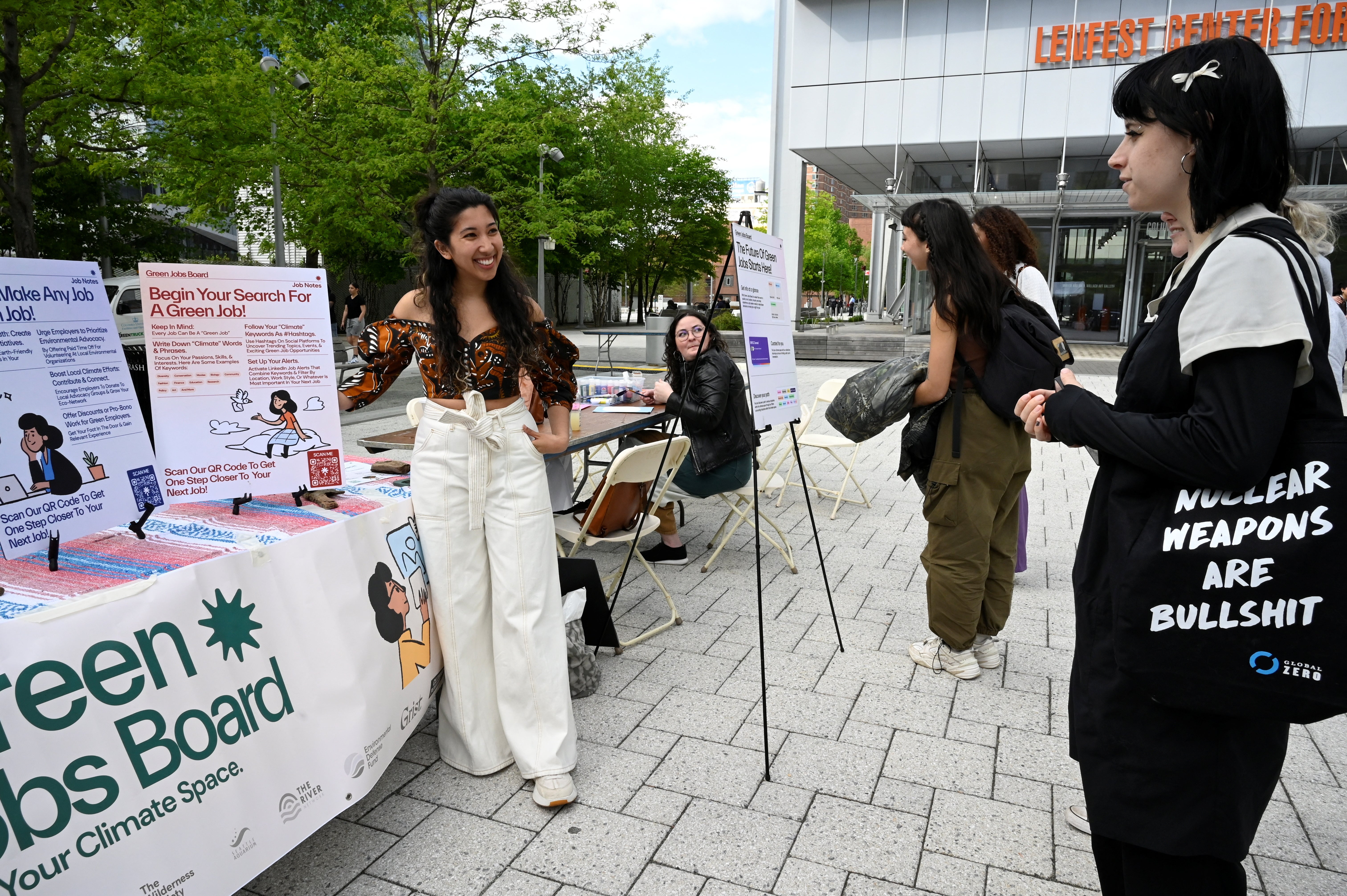 Drutman, 27, talks with a student at an event to discuss environmental news and social media at the Columbia Climate School, in New York City