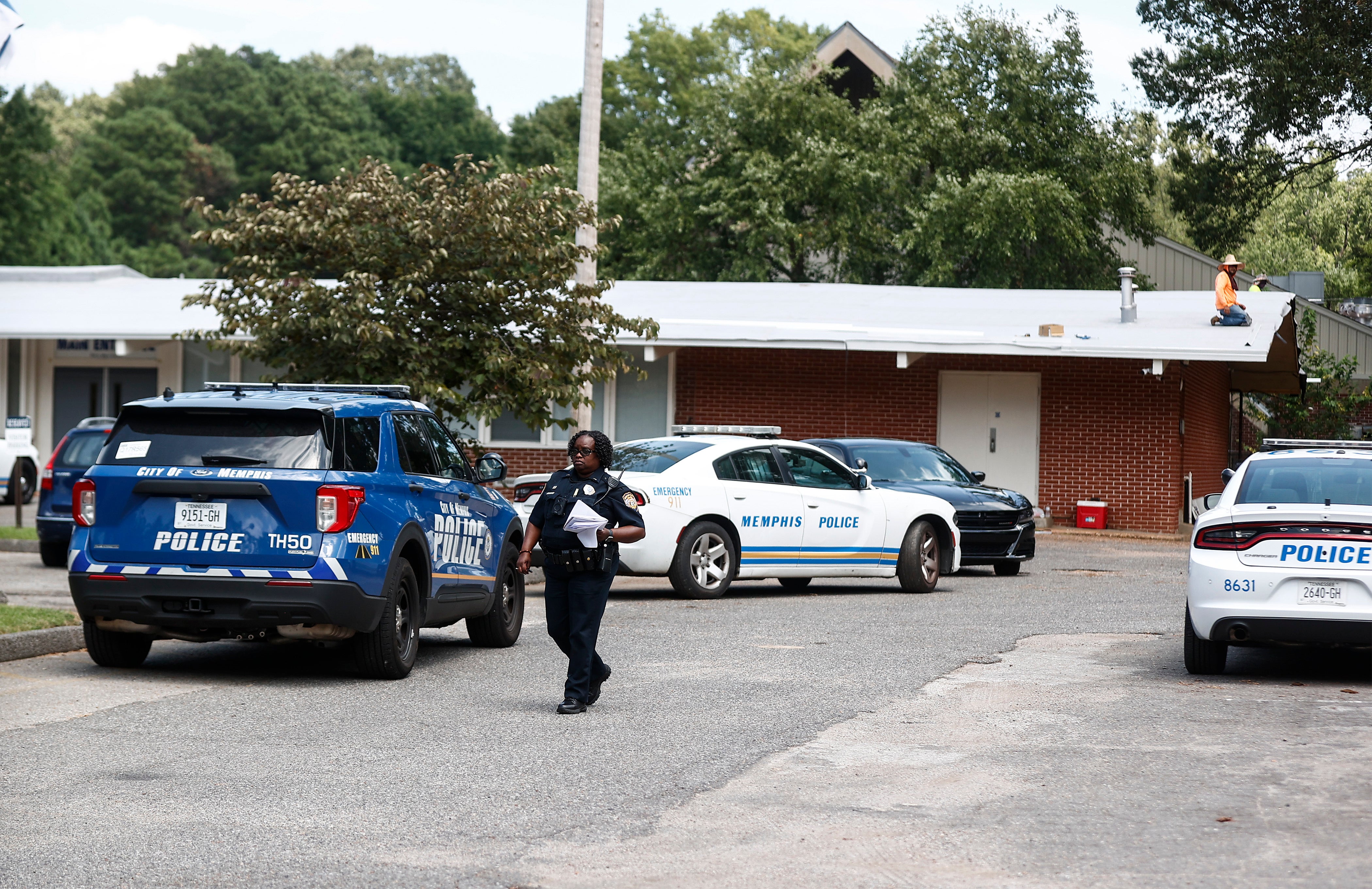 A Memphis Police officer walks on the scene of a shooting at Margolin Hebrew School on Monday, July 31, 2023 in Memphis, Tenn.