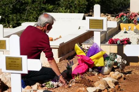 David Hunter lays flowers at the grave of his wife Janice Hunter at a cemetery near their former home in Paphos, Cyprus