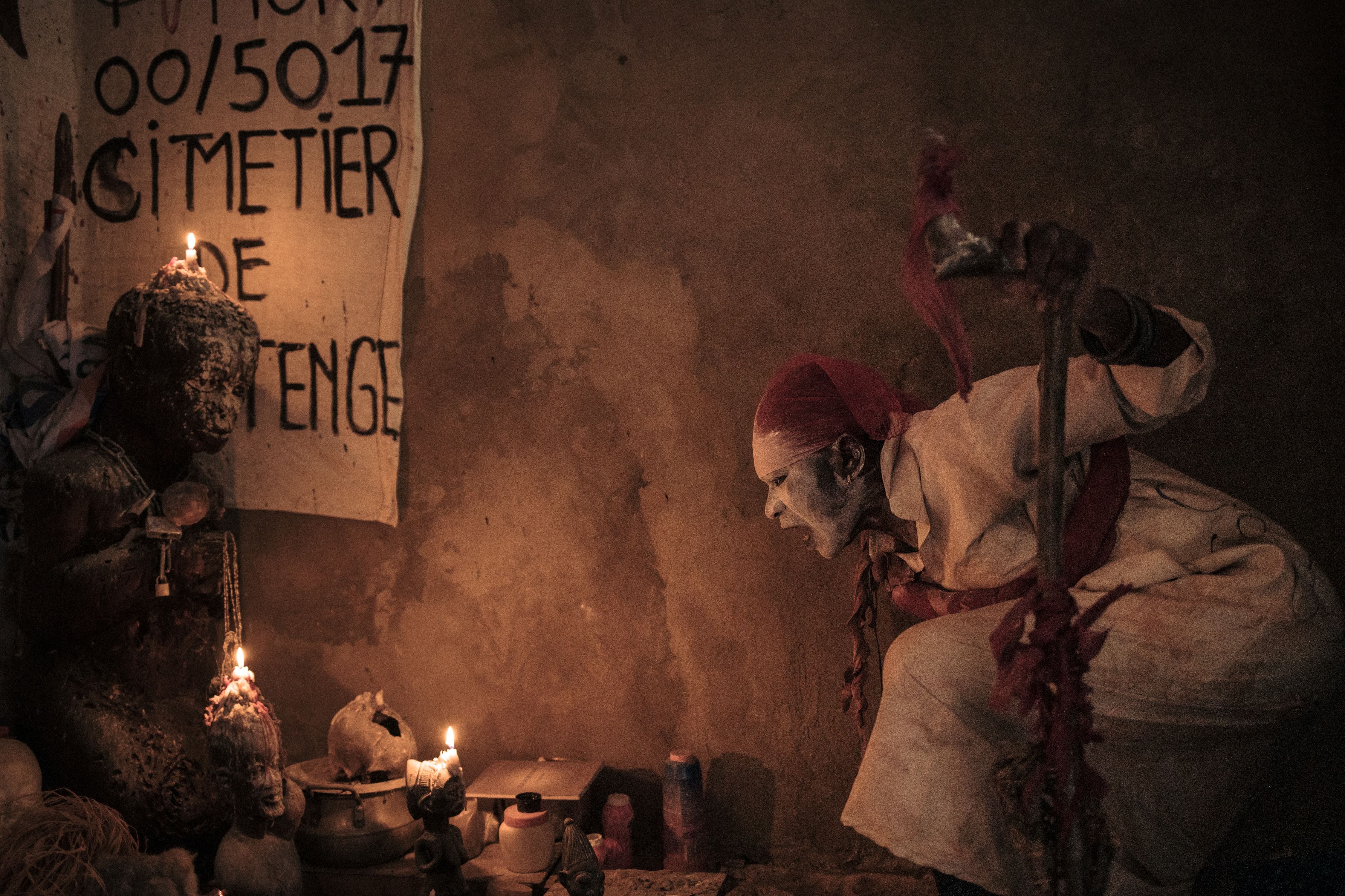 A ‘voodoo’ wrestler utters incantations above the alter of his shrine in Kinshasa, Democratic Republic of Congo