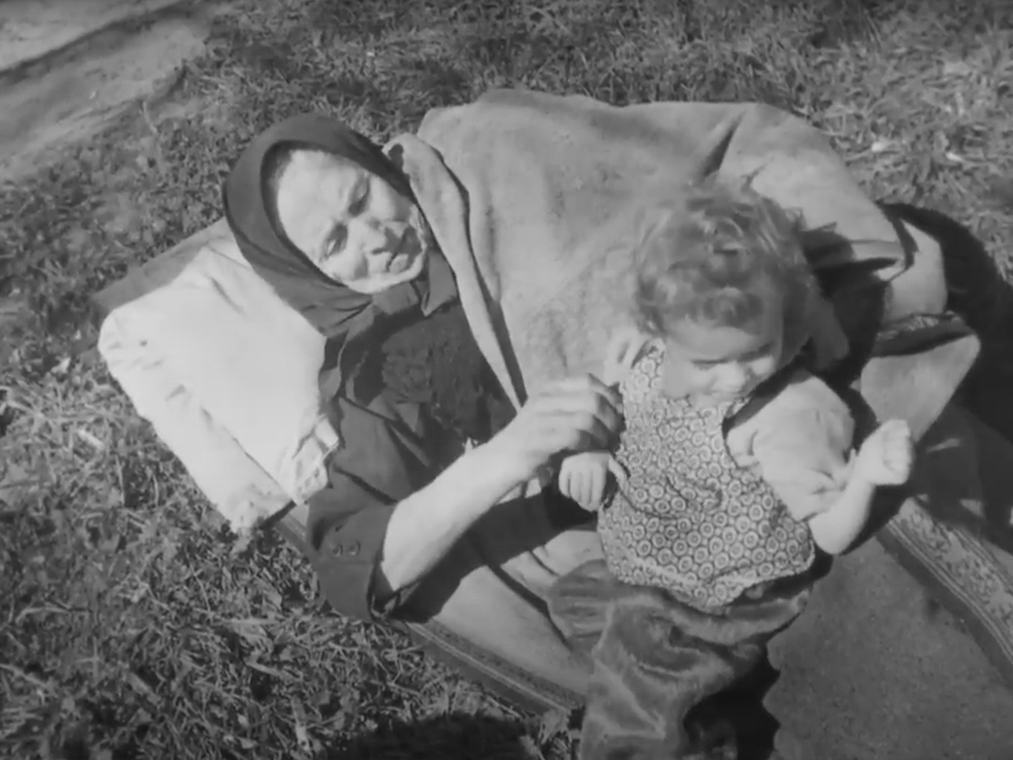 A woman and young child by the train in Farsleben, after leaving Bergen-Belsen concentration camp