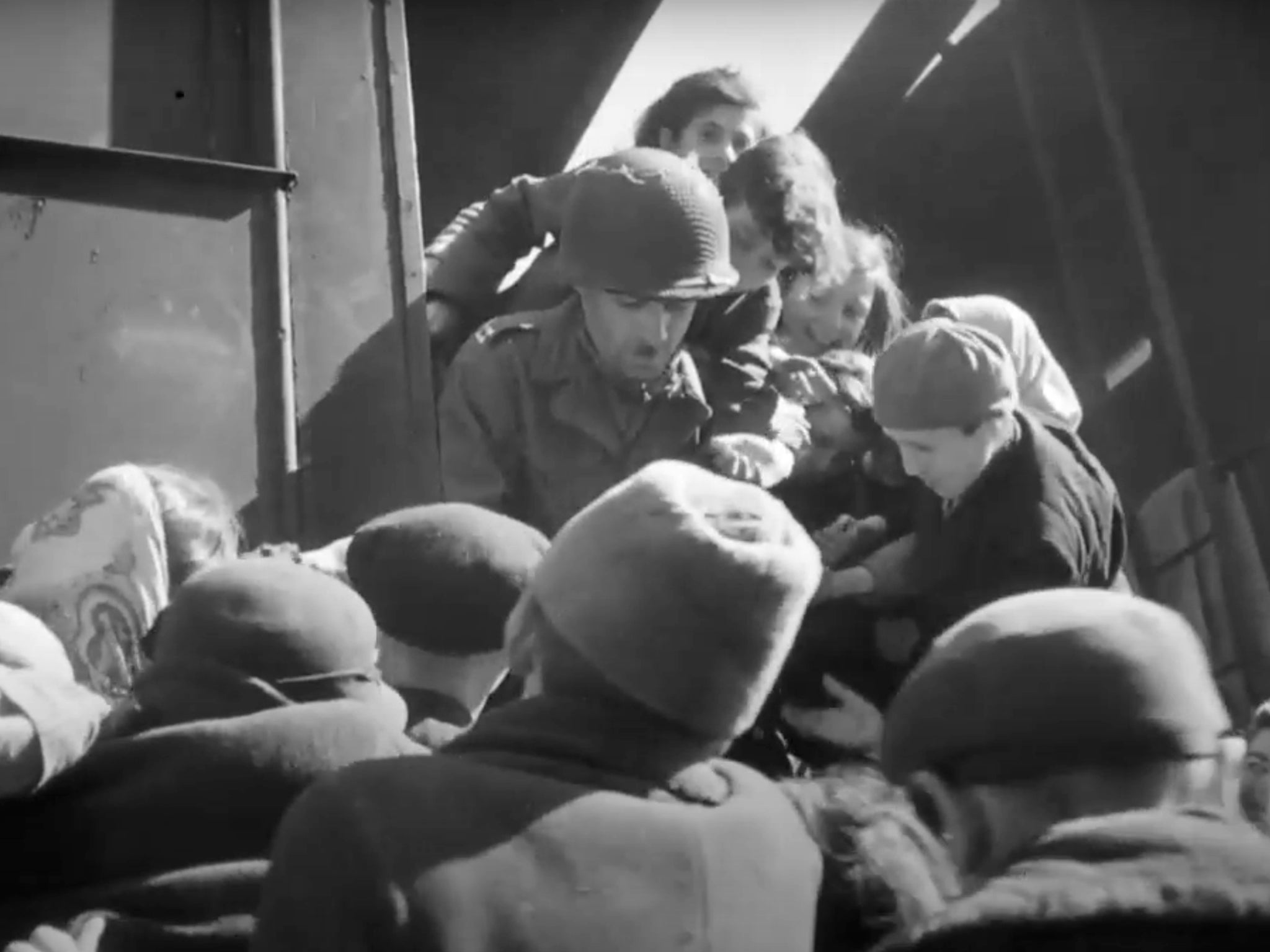 An American GI hands out sweets and supplies