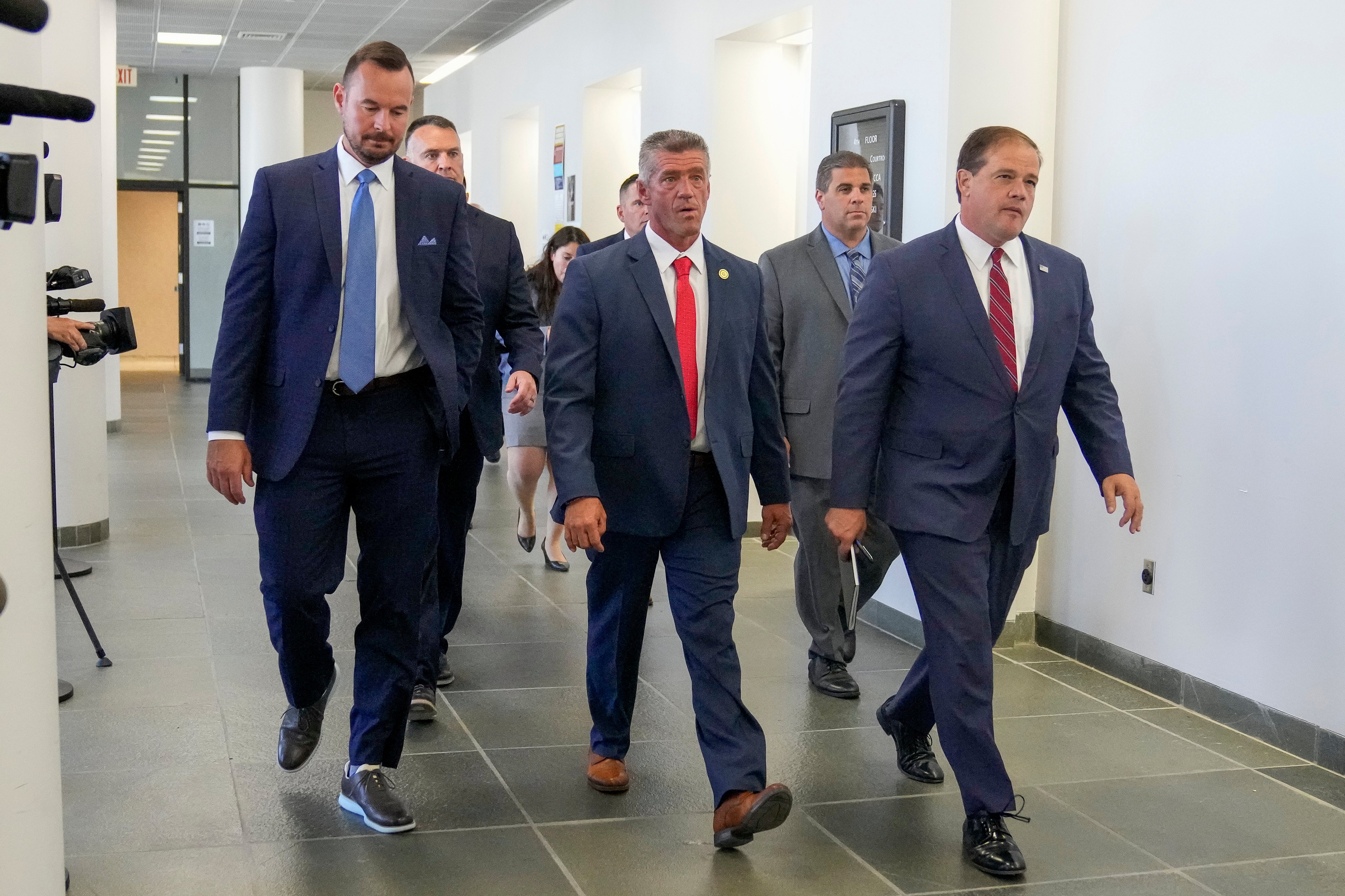 Suffolk County District Attorney Ray Tierney, right, arrives for a court appearance in the case against Rex Heuermann