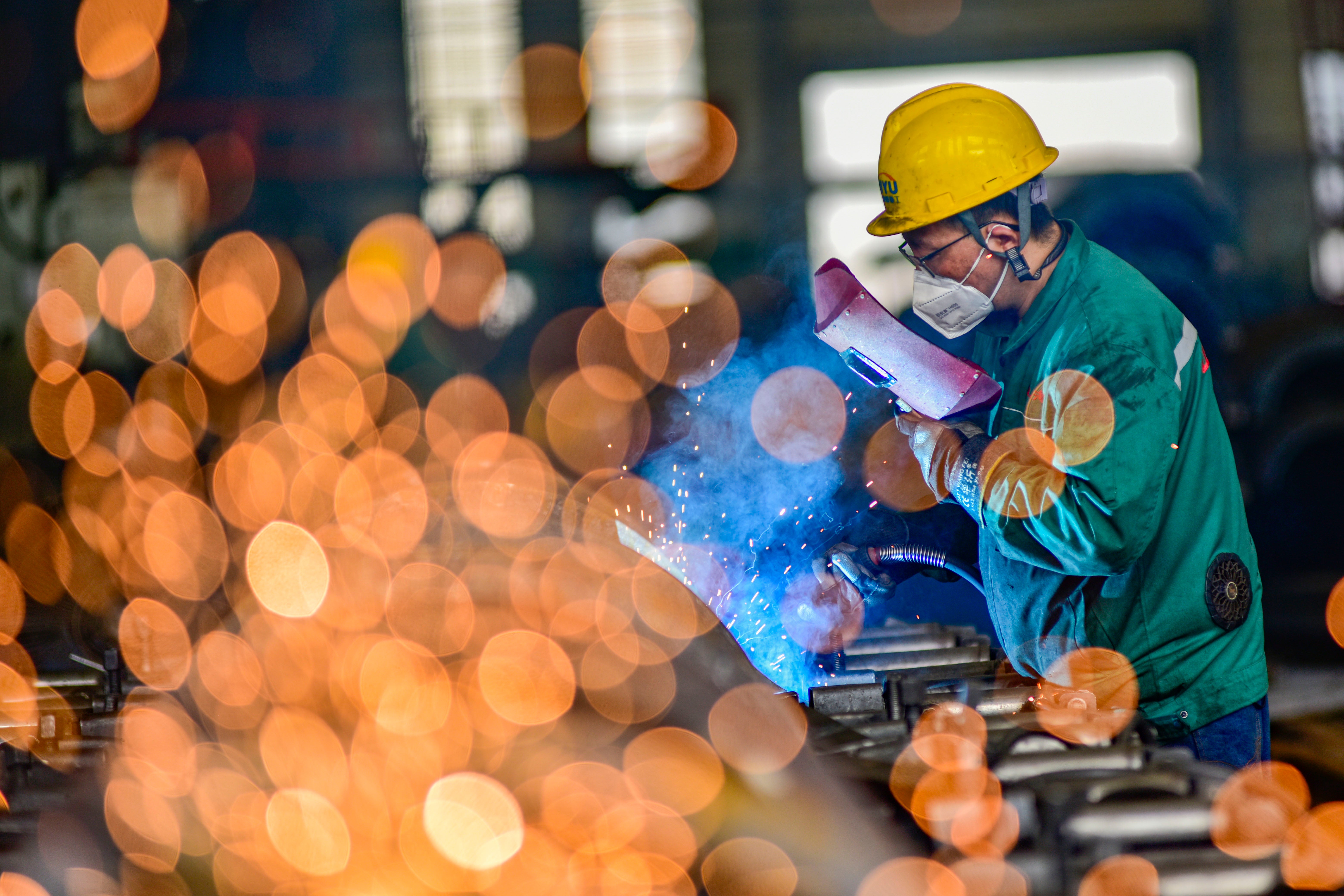 A worker welds materials at a factory in Qingzhou, Shandong province, on July 17