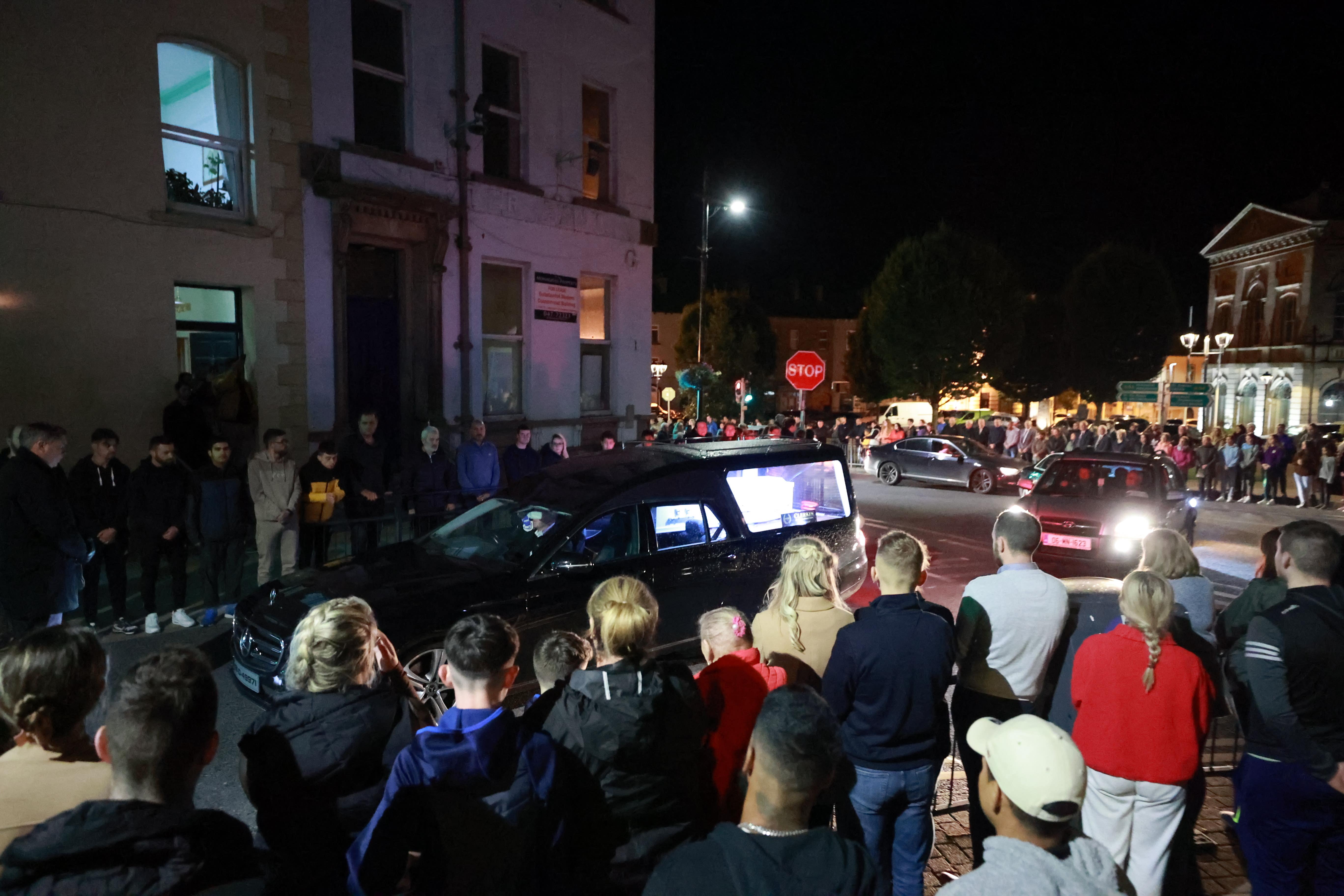 People form a guard of honour as the hearse carrying the remains of Kiea McCann arrives to the family home in Clones, Co. Monaghan. Kiea, 17, and Dlava Mohamed, 16, both students at Largy College in Clones, were killed, and three others were injured on the N54 Clones to Smithborough road at Legnakelly, Co. Monaghan, after a road traffic collision at around 6.45pm on Monday. Issue date: Tuesday August 1, 2023.