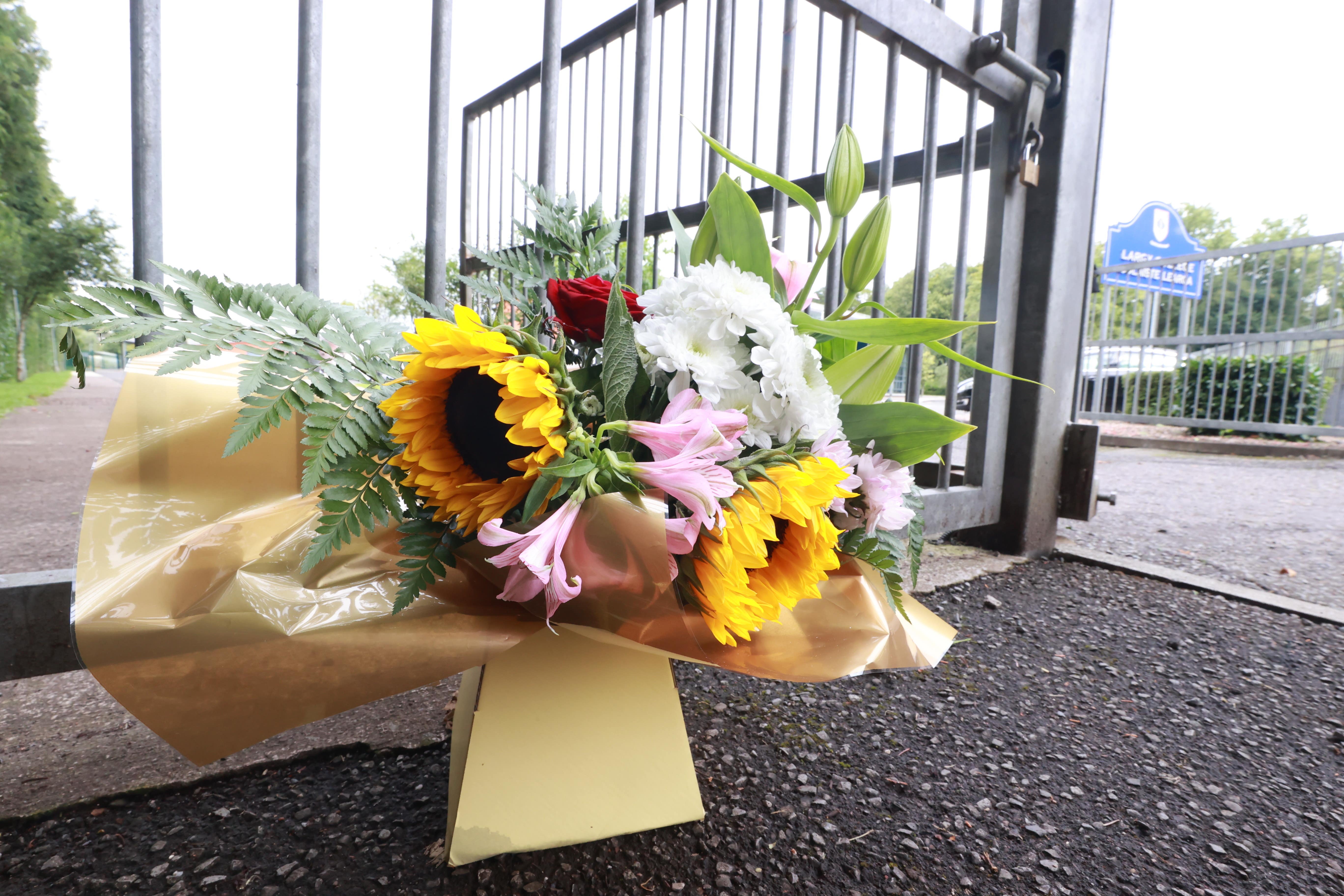 Flowers outside Largy College in Clones after two of its teenage pupils were killed (PA)