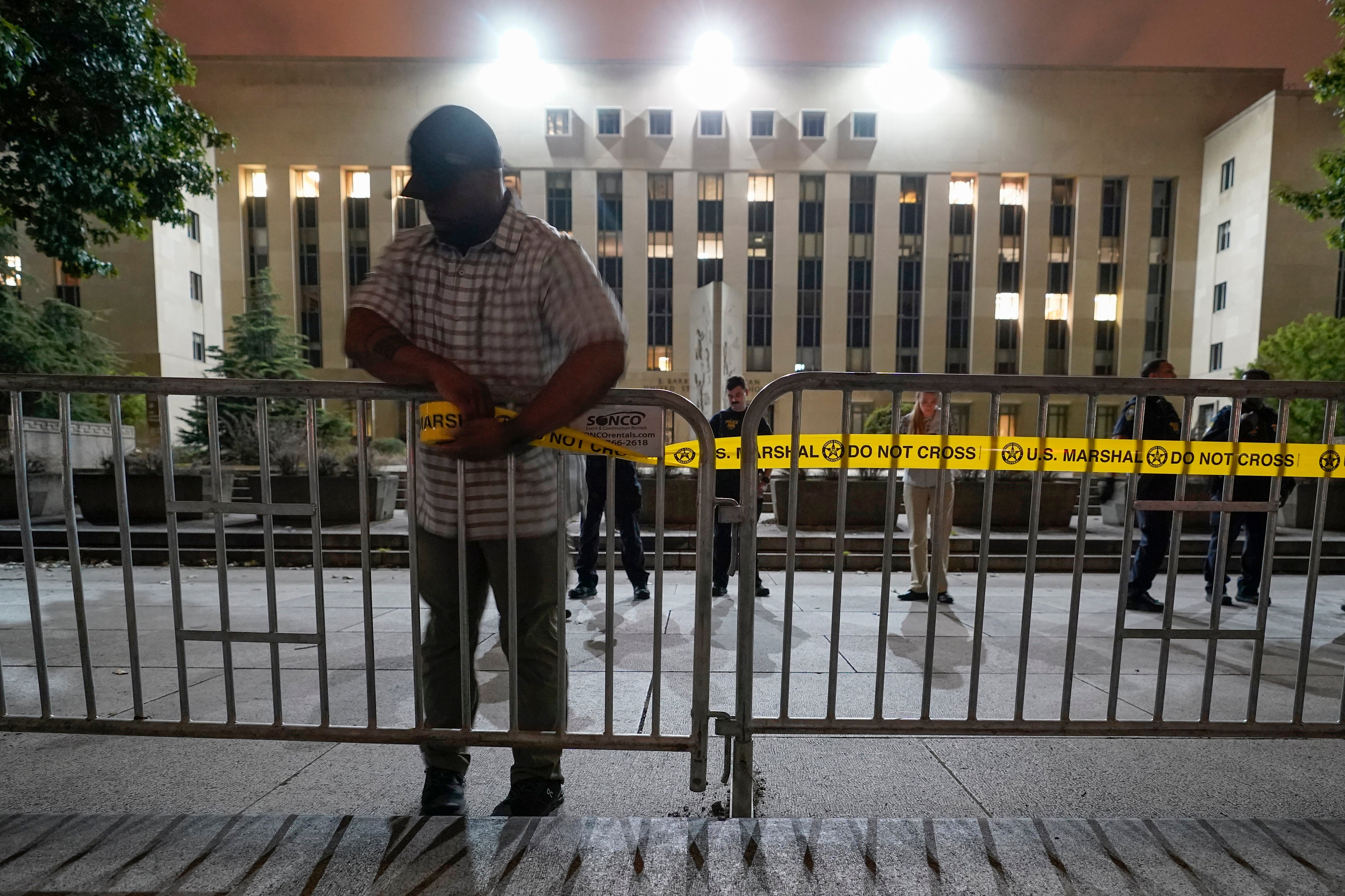 Workers put up barricades and secure the area