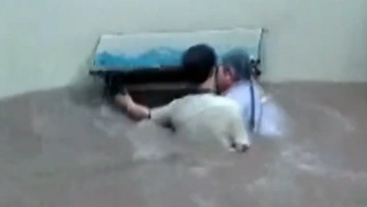 China floods: Elderly woman rescued by man who cannot swim