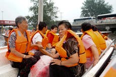 Deadly flooding in China worsens as rescues continue and areas downriver brace for high water