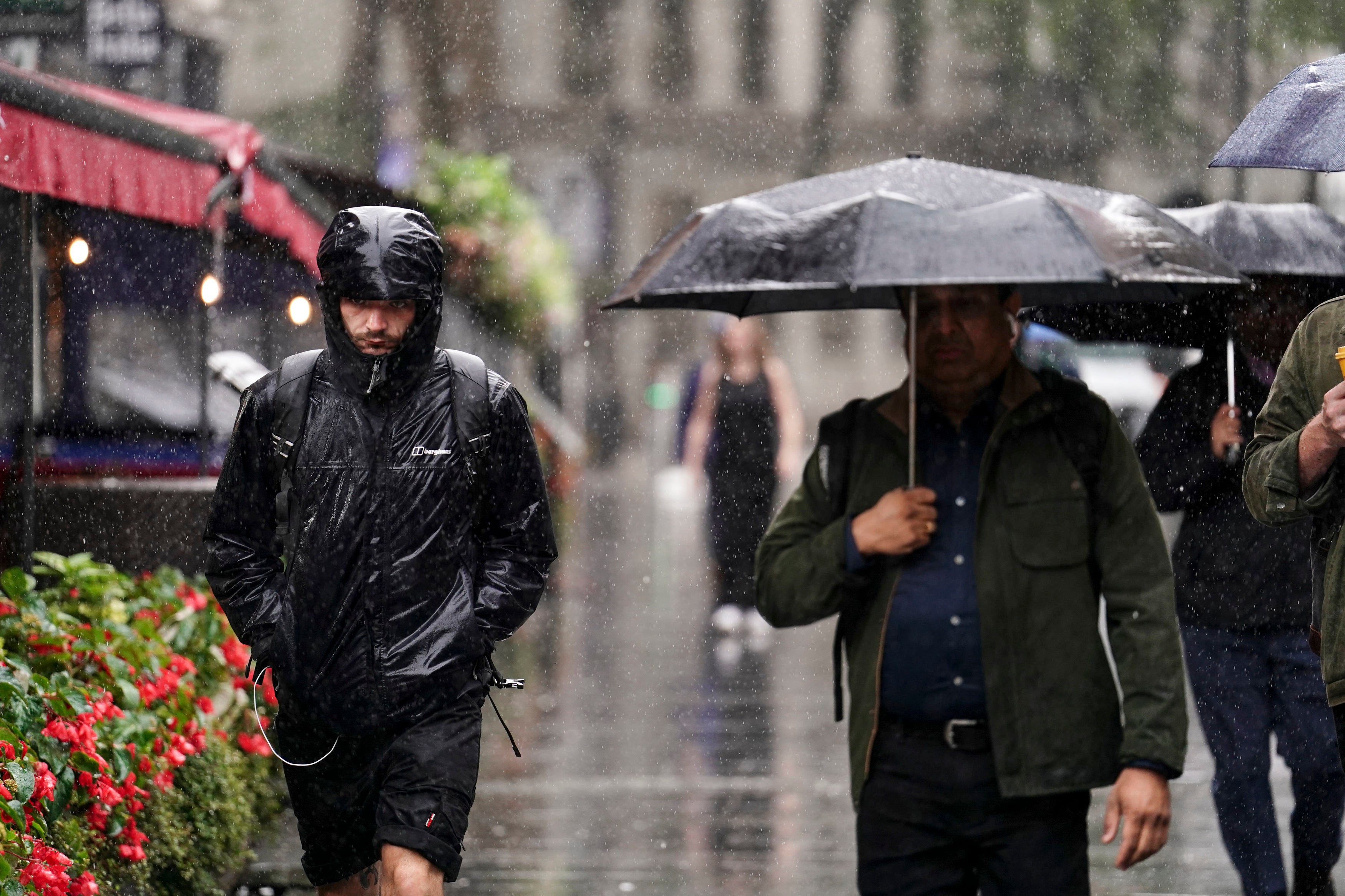 People caught during a heavy downpour of rain in Leicester Square, London, Wednesday 2 August