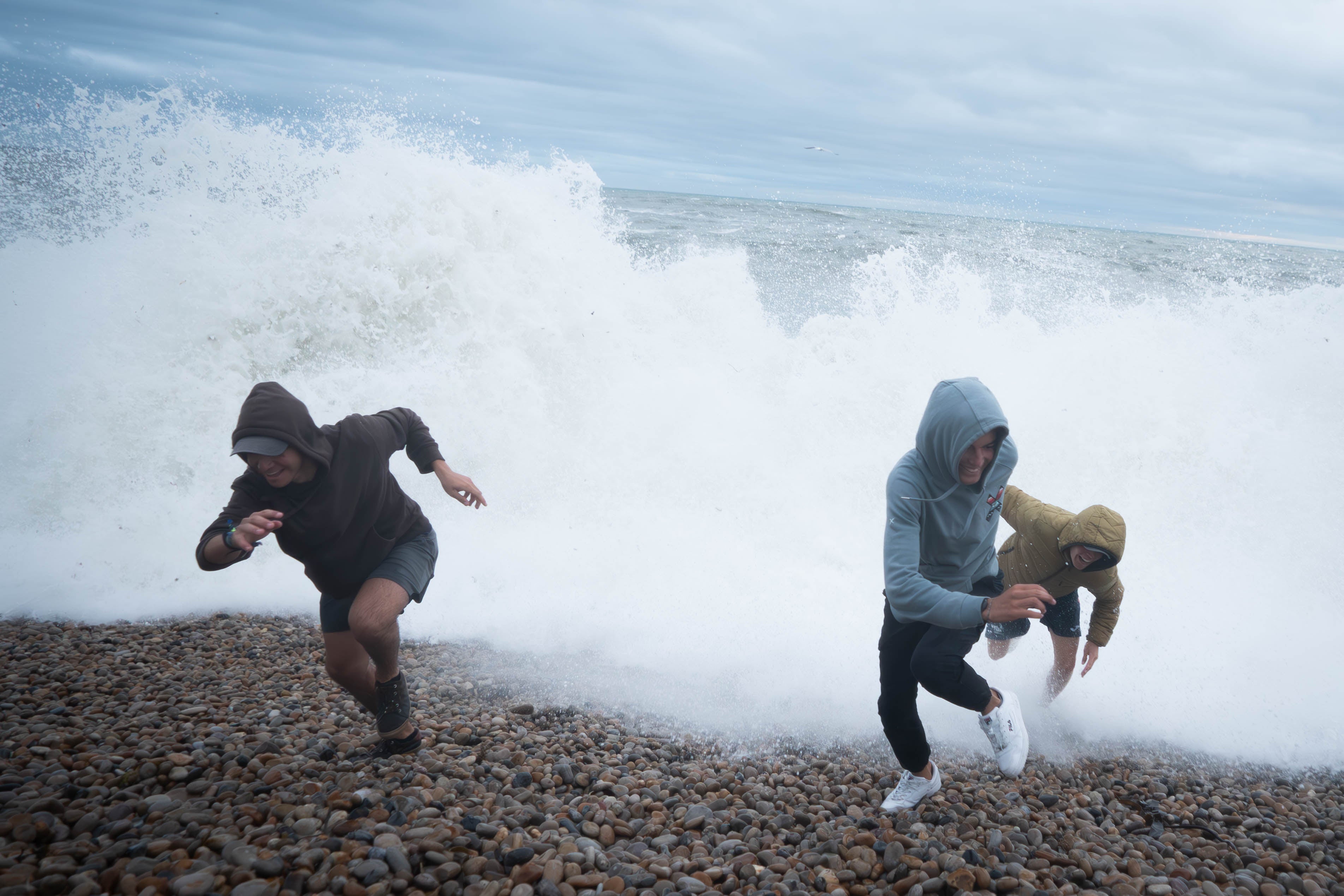 People play amongst the waves on Chiswell Beach in Dorset, Wednesday 2 August